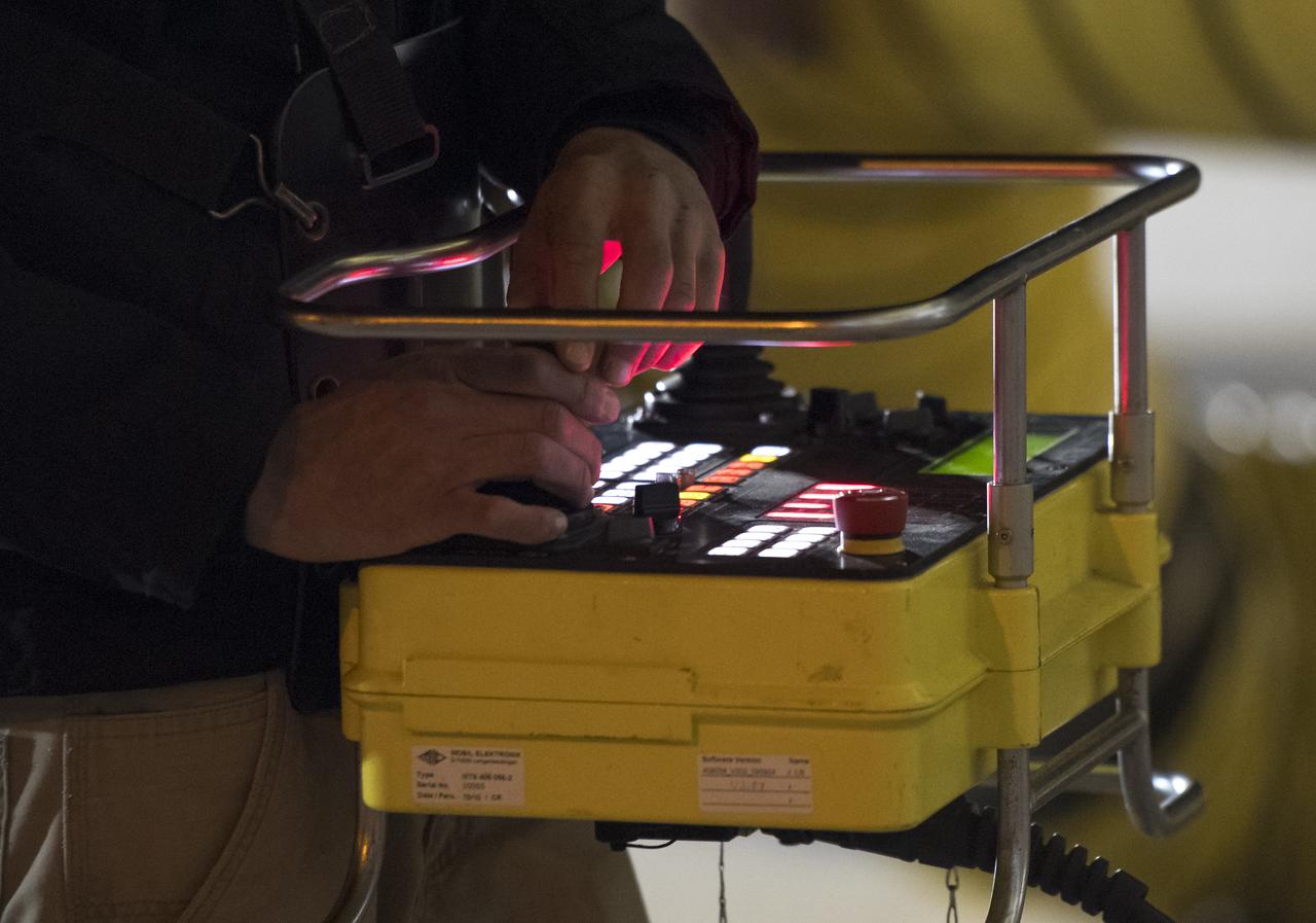 Orbital ATK Mechanical Technician Phil Kauthen drives the transporter with the Antares rocket aboard from the Horizontal Integration Facility to launch Pad-0A, Thursday, Nov. 9, 2017 at NASA's Wallops Flight Facility in Virginia. Orbital ATK’s eighth contracted cargo resupply mission with NASA to the International Space Station will deliver over 7,400 pounds of science and research, crew supplies and vehicle hardware to the orbital laboratory and its crew. Photo Credit: (NASA/Bill Ingalls)