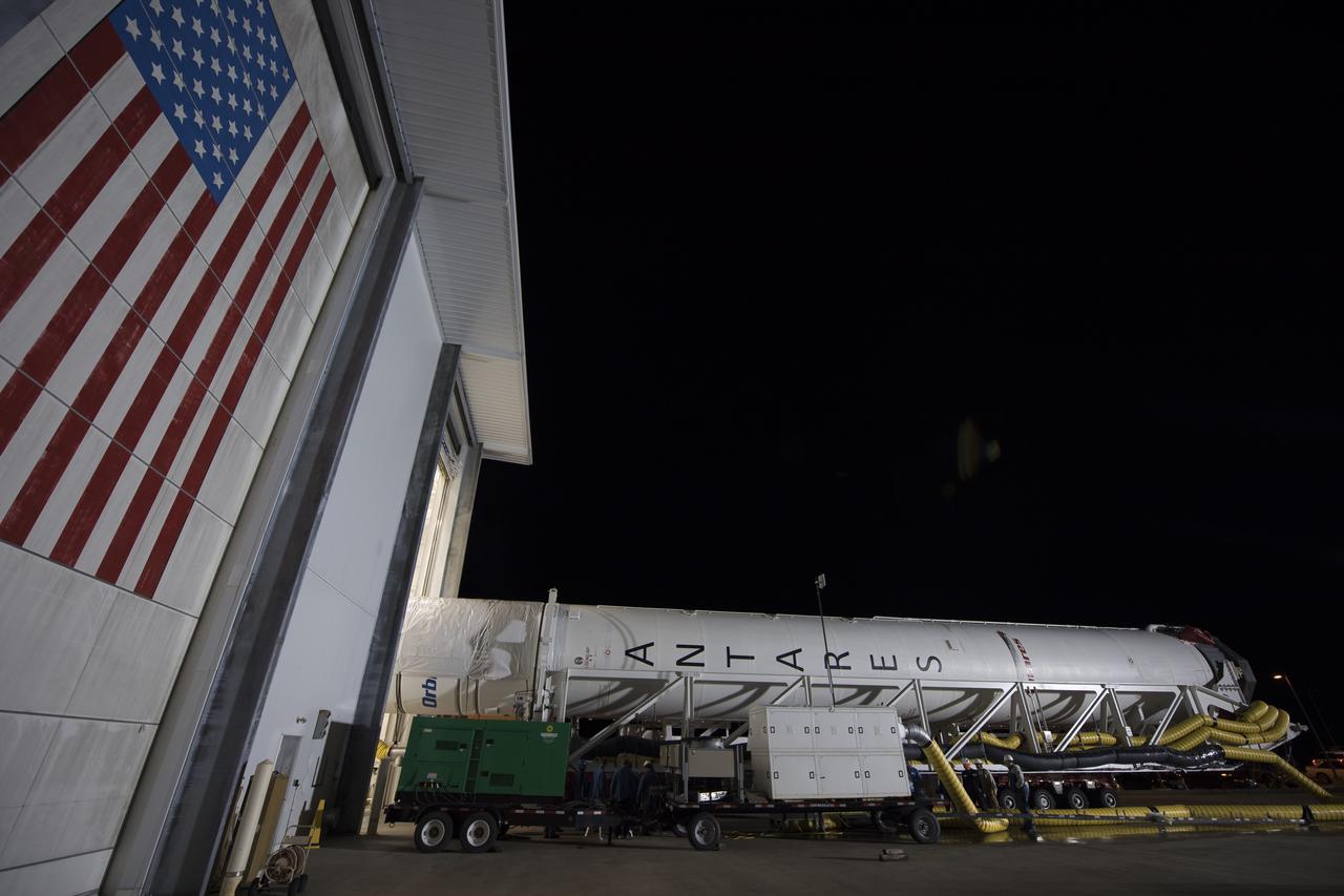 The Orbital ATK Antares rocket is rolled from the Horizontal Integration Facility (HIF) to launch Pad-0A, Thursday, Nov. 9, 2017 at NASA's Wallops Flight Facility in Virginia. Orbital ATK’s eighth contracted cargo resupply mission with NASA to the International Space Station will deliver over 7,400 pounds of science and research, crew supplies and vehicle hardware to the orbital laboratory and its crew. Photo Credit: (NASA/Bill Ingalls)