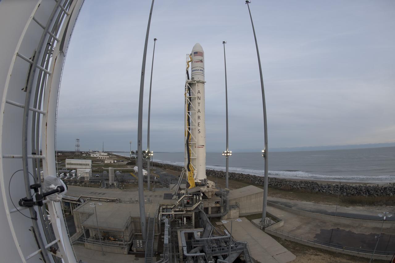 A fisheye lens view of the Orbital ATK Antares rocket, with the Cygnus spacecraft onboard, Saturday, Nov. 11, 2017 at NASA's Wallops Flight Facility, launch Pad-0A, in Virginia. Orbital ATK’s eighth contracted cargo resupply mission with NASA to the International Space Station will deliver approximately 7,400 pounds of science and research, crew supplies and vehicle hardware to the orbital laboratory and its crew. Photo Credit: (NASA/Bill Ingalls)
