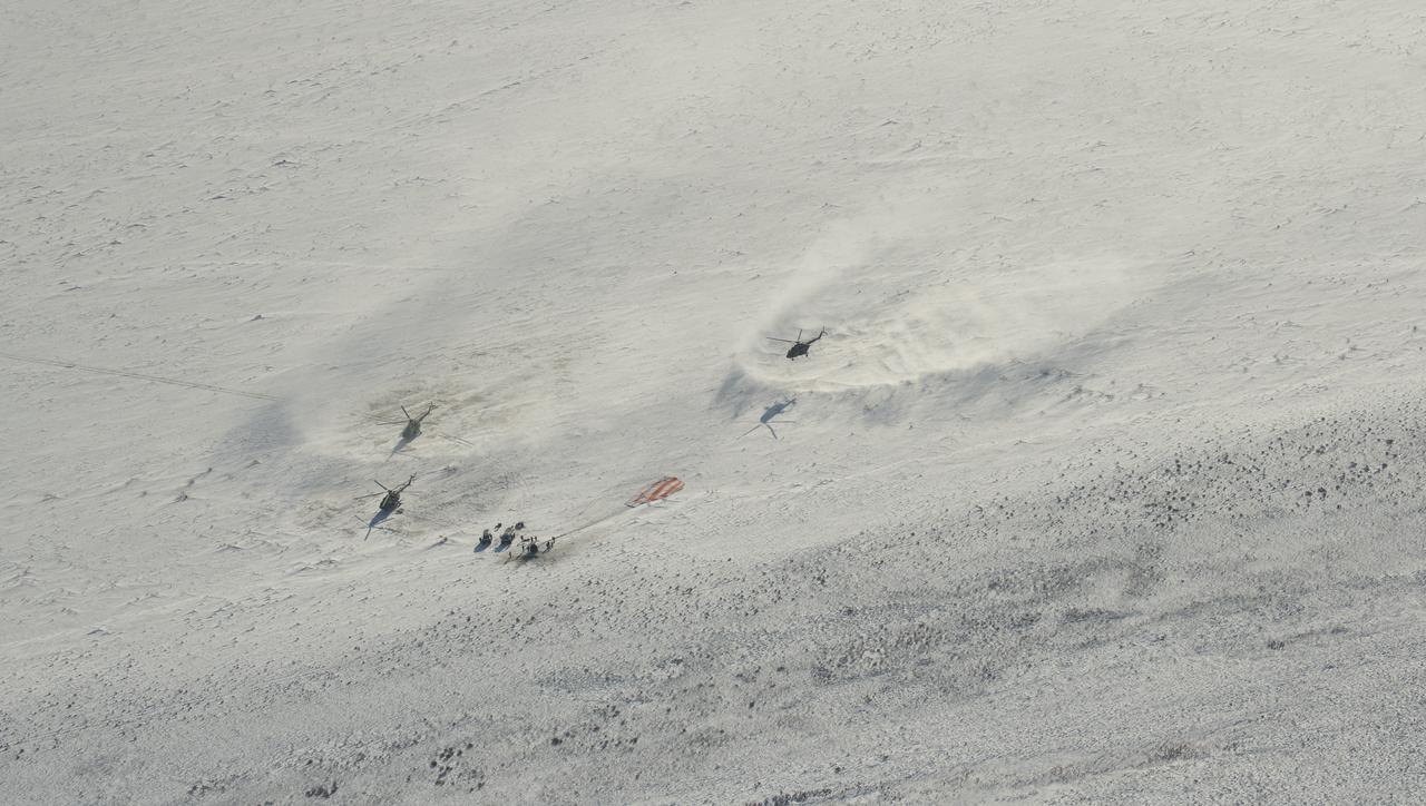 Russian Search and Rescue teams arrive at the Soyuz MS-05 spacecraft shortly after it landed with Expedition 53 Commander Randy Bresnik of NASA and Flight Engineers Paolo Nespoli of ESA (European Space Agency) and Sergey Ryazanskiy of the Russian space agency Roscosmos near the town of Zhezkazgan, Kazakhstan on Thursday, Dec. 14, 2017. Bresnik, Nespoli and Ryazanskiy are returning after 139 days in space where they served as members of the Expedition 52 and 53 crews onboard the International Space Station. Photo Credit: (NASA/Bill Ingalls)