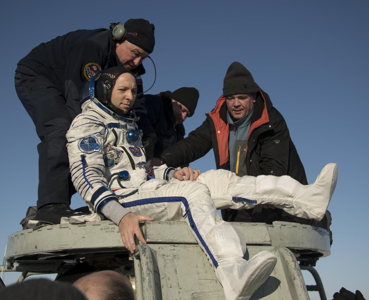 NASA astronaut Randy Bresnik is helped out of the Soyuz MS-05 spacecraft just minutes after he, ESA (European Space Agency) astronaut Paolo Nespoli, and Roscosmos cosmonaut Sergey Ryazanskiy, landed in a remote area near the town of Zhezkazgan, Kazakhstan on Thursday, Dec. 14, 2017. Bresnik, Nespoli and Ryazanskiy are returning after 139 days in space where they served as members of the Expedition 52 and 53 crews onboard the International Space Station. Photo Credit: (NASA/Bill Ingalls)