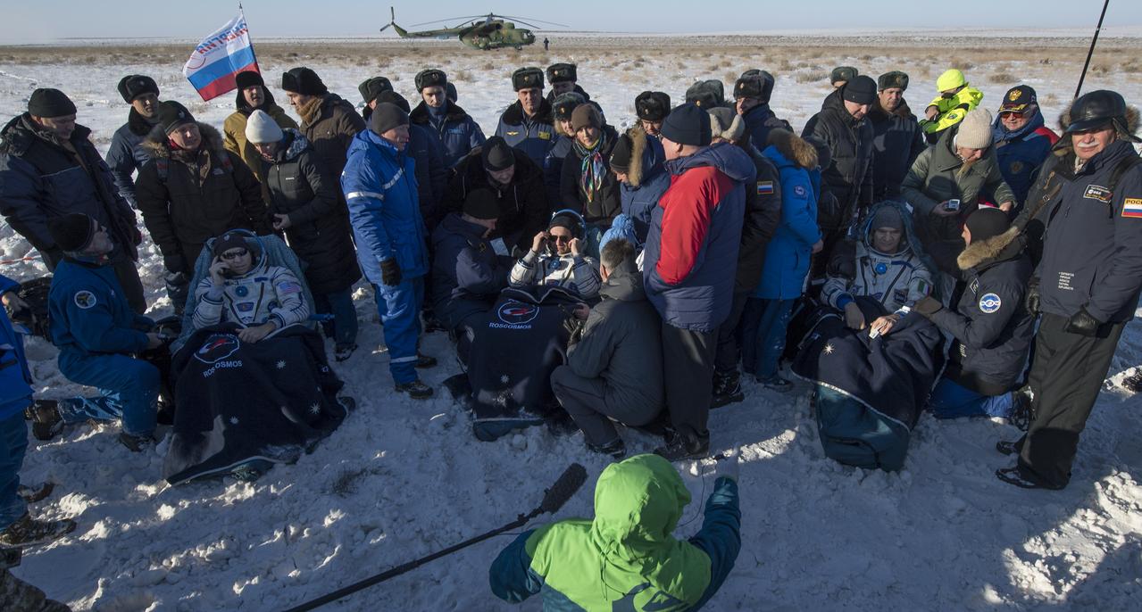 NASA astronaut Randy Bresnik, left, Roscosmos cosmonaut Sergey Ryazanskiy, center, and ESA (European Space Agency) astronaut Paolo Nespoli sit in chairs outside the Soyuz MS-05 spacecraft a few moments after they landed in a remote area near the town of Zhezkazgan, Kazakhstan on Thursday, Dec. 14, 2017. Bresnik, Nespoli and Ryazanskiy are returning after 139 days in space where they served as members of the Expedition 52 and 53 crews onboard the International Space Station. Photo Credit: (NASA/Bill Ingalls)