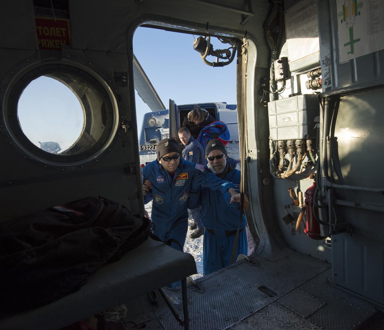 NASA astronaut Randy Bresnik enters a helicopter shortly after he, ESA (European Space Agency) astronaut Paolo Nespoli, and Roscosmos cosmonaut Sergey Ryazanskiy landed in their Soyuz MS-05 spacecraft in a remote area near the town of Zhezkazgan, Kazakhstan on Thursday, Dec. 14, 2017. Bresnik, Nespoli and Ryazanskiy are returning after 139 days in space where they served as members of the Expedition 52 and 53 crews onboard the International Space Station. Photo Credit: (NASA/Bill Ingalls)