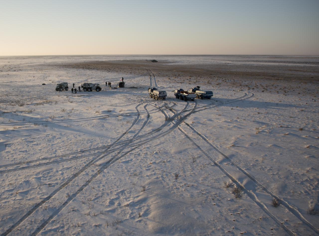 Russian support personnel work around the Soyuz MS-05 spacecraft shortly after it landed with Expedition 53 Commander Randy Bresnik of NASA and Flight Engineers Paolo Nespoli of ESA (European Space Agency) and Sergey Ryazanskiy of the Russian space agency Roscosmos near the town of Zhezkazgan, Kazakhstan on Thursday, Dec. 14, 2017. Bresnik, Nespoli and Ryazanskiy are returning after 139 days in space where they served as members of the Expedition 52 and 53 crews onboard the International Space Station. Photo Credit: (NASA/Bill Ingalls)