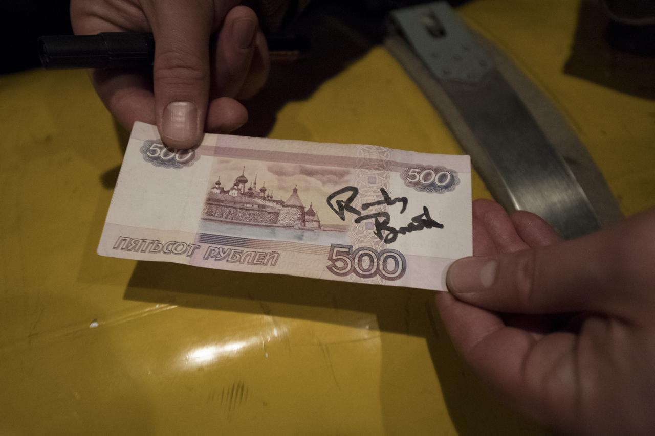 The autograph of NASA astronaut Randy Bresnik is seen on a Russian 500 ruble note during the helicopter ride from the Expedition 53 landing zone to Zhezkazgan, Kazakhstan, Thursday, Dec. 14, 2017. Expedition 53 Commander Randy Bresnik of NASA and Flight Engineers Paolo Nespoli of ESA (European Space Agency) and Sergey Ryazanskiy of the Russian space agency Roscosmos returned after 139 days in space where they served as members of the Expedition 52 and 53 crews onboard the International Space Station. Photo Credit: (NASA/Bill Ingalls)