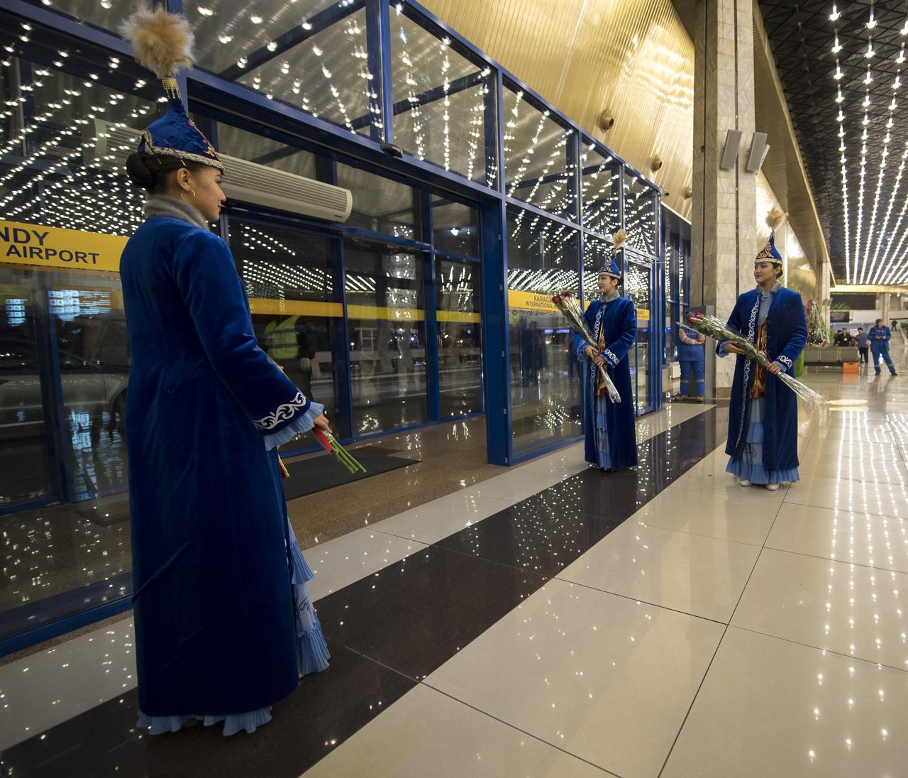 Girls in traditional Kazakhstan dress wait to welcome the return of Expedition 53 Commander Randy Bresnik of NASA and Flight Engineers Paolo Nespoli of ESA (European Space Agency) and Sergey Ryazanskiy of the Russian space agency Roscosmos at a Karaganda Airport welcome ceremony in Kazakhstan on Thursday, Dec. 14, 2017. 2017. Bresnik, Nespoli and Ryazanskiy are returning after 139 days in space where they served as members of the Expedition 52 and 53 crews onboard the International Space Station. Photo Credit: (NASA/Bill Ingalls)