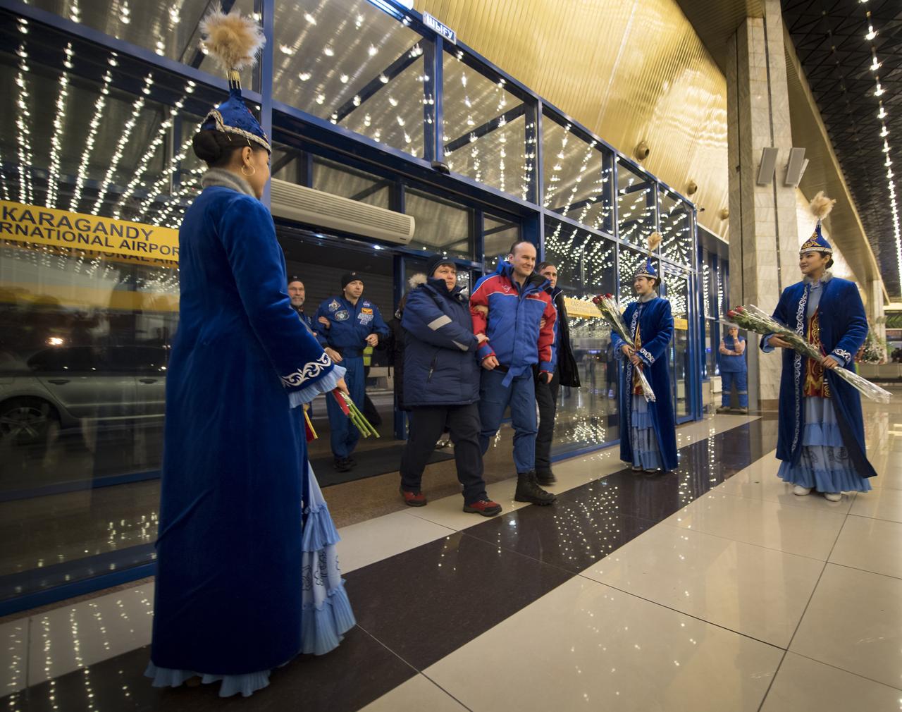 Roscosmos cosmonaut Sergey Ryazanskiy, foreground, and NASA astronaut Randy Bresnik, background, arrive at the Karaganda Airport in Kazakhstan airport after they and ESA (European Space Agency) astronaut Paolo Nespoli landed in their Soyuz MS-05 spacecraft in a remote area near the town of Zhezkazgan, Kazakhstan on Thursday, Dec. 14, 2017. Bresnik, Nespoli and Ryazanskiy are returning after 139 days in space where they served as members of the Expedition 52 and 53 crews onboard the International Space Station. Photo Credit: (NASA/Bill Ingalls)