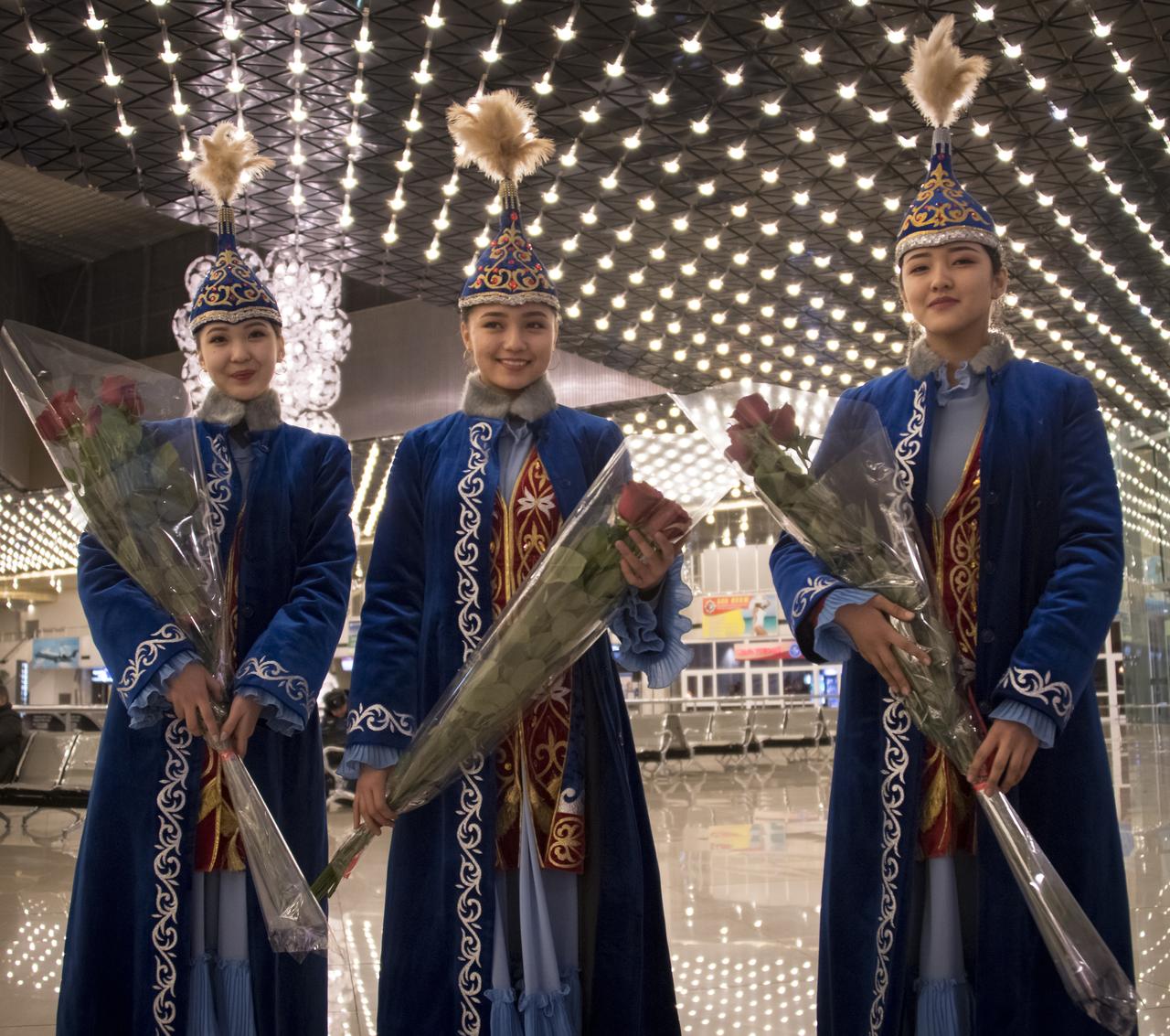 Girls in traditional Kazakhstan dress wait to welcome the return of Expedition 53 Commander Randy Bresnik of NASA and Flight Engineers Paolo Nespoli of ESA (European Space Agency) and Sergey Ryazanskiy of the Russian space agency Roscosmos at a Karaganda Airport welcome ceremony in Kazakhstan on Thursday, Dec. 14, 2017. 2017. Bresnik, Nespoli and Ryazanskiy are returning after 139 days in space where they served as members of the Expedition 52 and 53 crews onboard the International Space Station. Photo Credit: (NASA/Bill Ingalls)