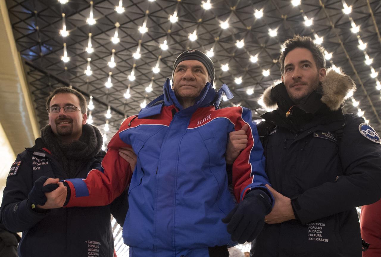 ESA (European Space Agency) astronaut Paolo Nespoli, center, arrives at the Karaganda Airport in Kazakhstan airport after he, NASA astronaut Randy Bresnik and, Roscosmos cosmonaut Sergey Ryazanskiy landed in their Soyuz MS-05 spacecraft in a remote area near the town of Zhezkazgan, Kazakhstan on Thursday, Dec. 14, 2017. Bresnik, Nespoli and Ryazanskiy are returning after 139 days in space where they served as members of the Expedition 52 and 53 crews onboard the International Space Station. Photo Credit: (NASA/Bill Ingalls)