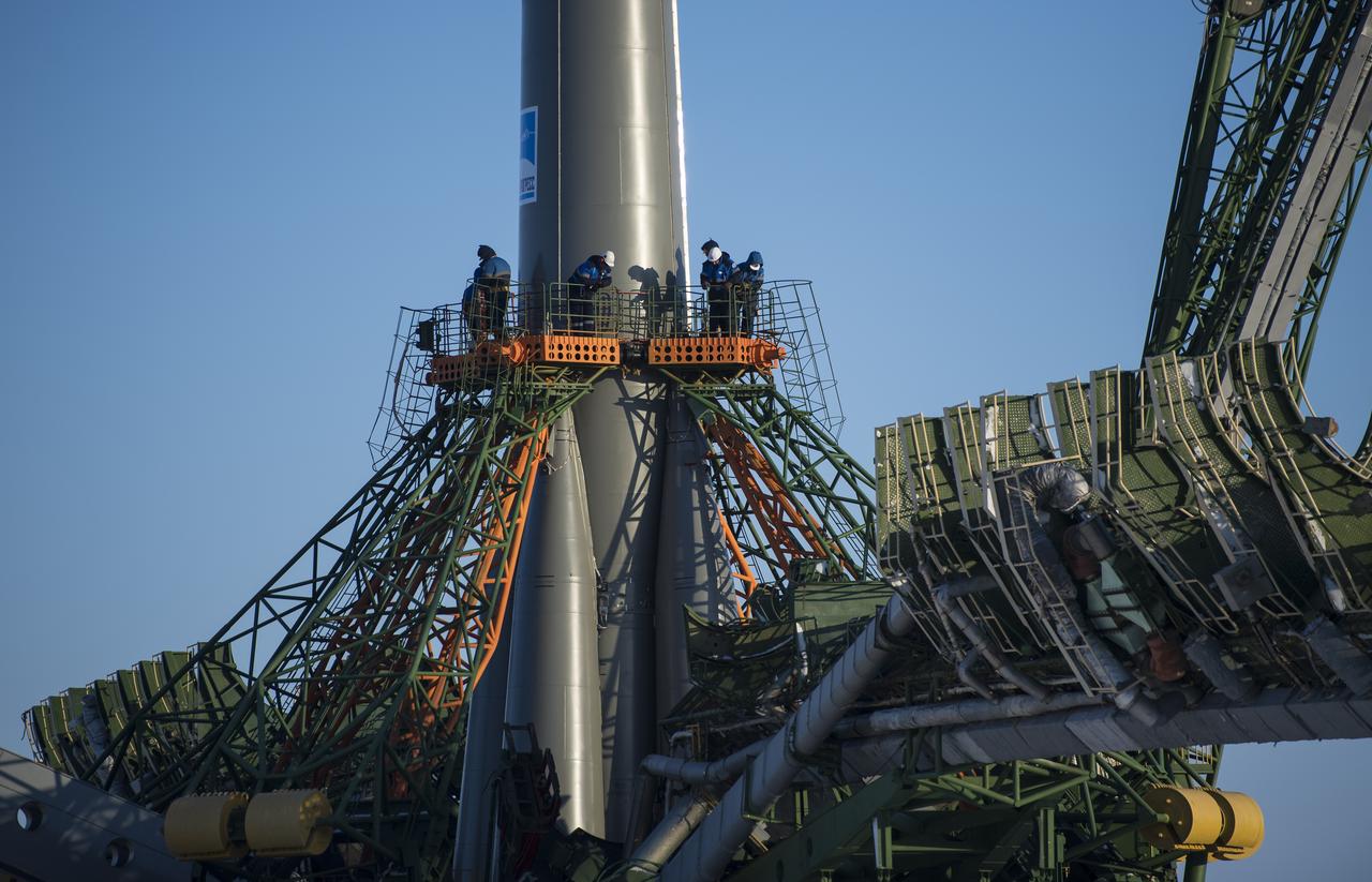 Workers are seen on a gantry as the service structure arms are raised around the Soyuz rocket, Friday, Dec. 15, 2017 at the Baikonur Cosmodrome in Kazakhstan. Expedition 54 Soyuz Commander Anton Shkaplerov of Roscosmos, flight engineer Scott Tingle of NASA, and flight engineer Norishige Kanai of the Japan Aerospace Exploration Agency (JAXA) are scheduled to launch at 2:21 a.m. Eastern Time (1:21 p.m. Baikonur time) on Dec. 17 and will spend the next five months living and working aboard the International Space Station.  Photo Credit: (NASA/Joel Kowsky)
