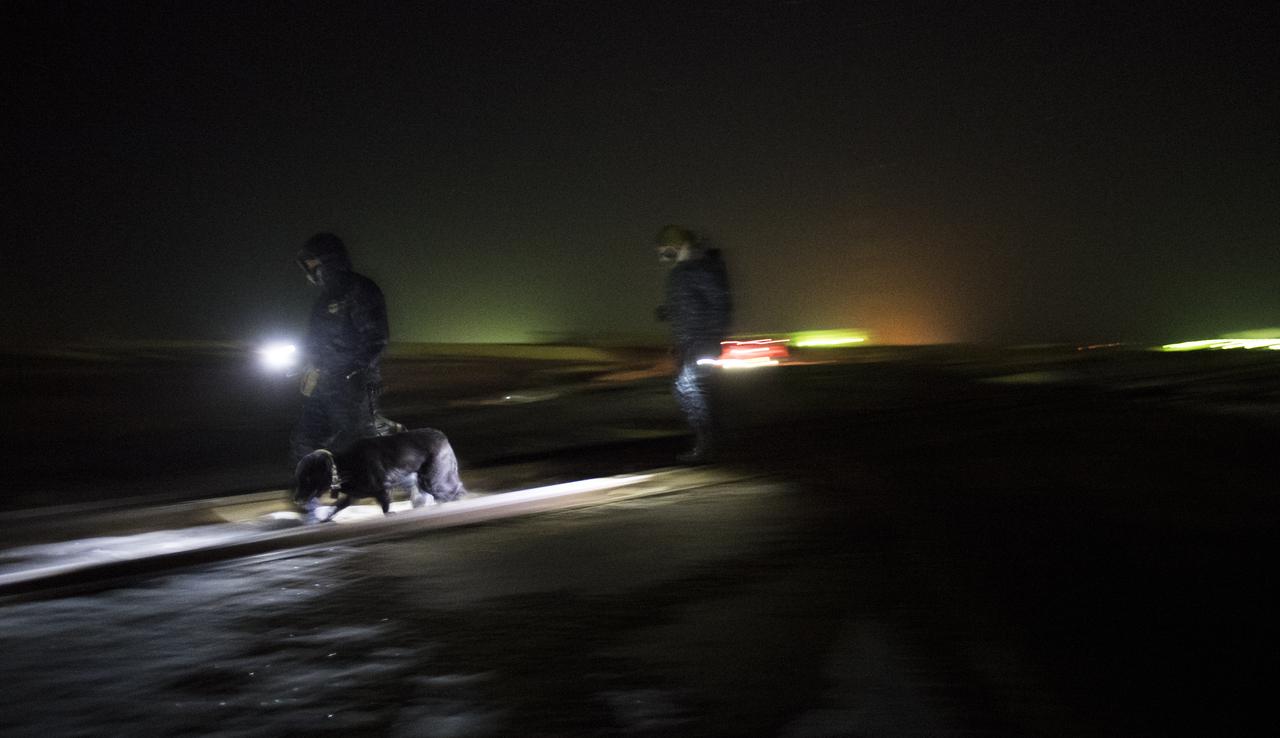 Security personnel walk along railroad tracks ahead of the Soyuz rocket as it is rolled out to the pad by train, Friday, Dec. 15, 2017 at the Baikonur Cosmodrome in Kazakhstan. Expedition 54 Soyuz Commander Anton Shkaplerov of Roscosmos, flight engineer Scott Tingle of NASA, and flight engineer Norishige Kanai of the Japan Aerospace Exploration Agency (JAXA) are scheduled to launch at 2:21 a.m. Eastern Time (1:21 p.m. Baikonur time) on Dec. 17 and will spend the next five months living and working aboard the International Space Station.  Photo Credit: (NASA/Joel Kowsky)