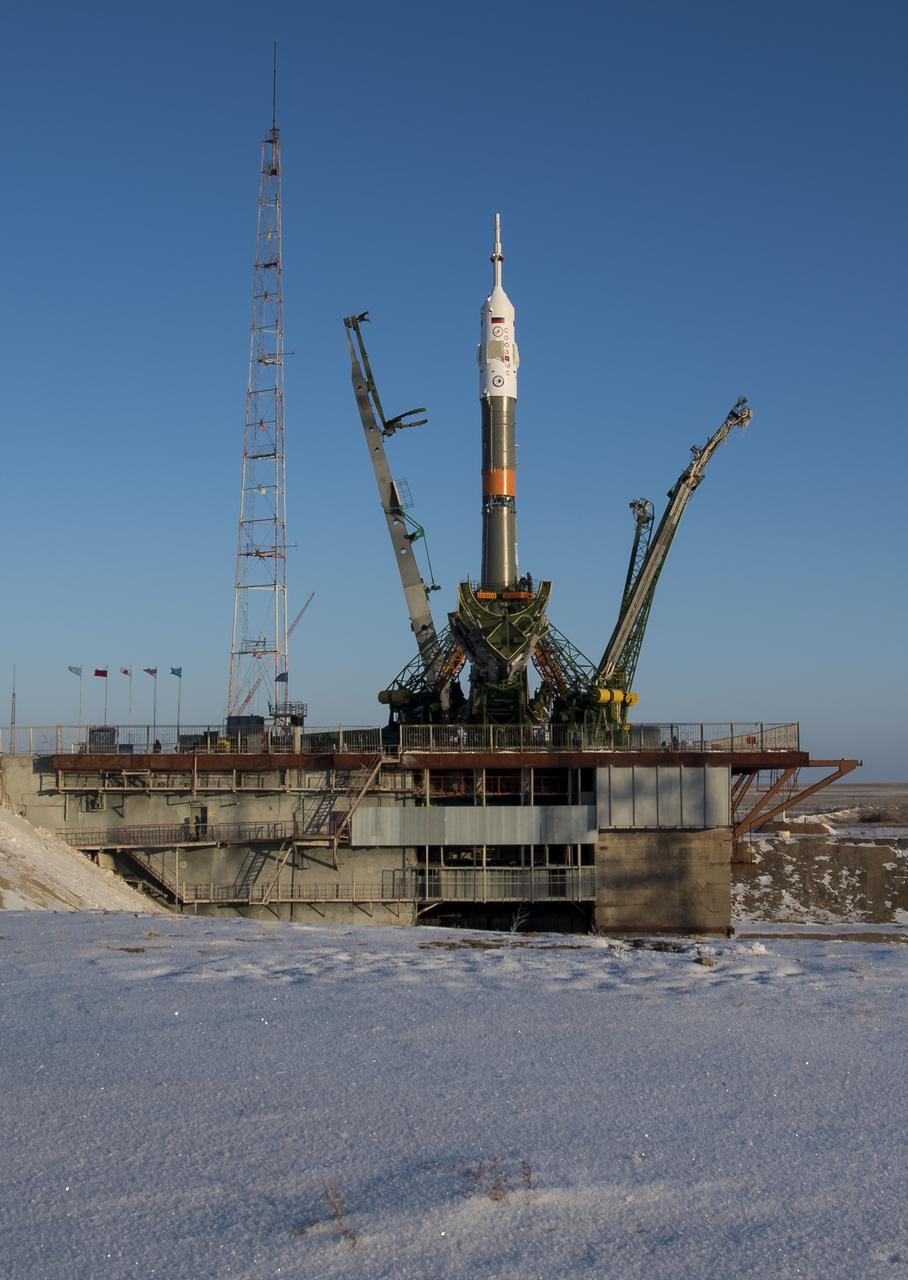 The Soyuz rocket is seen shortly after being raised into a vertical position on the launch pad, Friday, Dec. 15, 2017 at the Baikonur Cosmodrome in Kazakhstan. Expedition 54 Soyuz Commander Anton Shkaplerov of Roscosmos, flight engineer Scott Tingle of NASA, and flight engineer Norishige Kanai of the Japan Aerospace Exploration Agency (JAXA) are scheduled to launch at 2:21 a.m. Eastern Time (1:21 p.m. Baikonur time) on Dec. 17 and will spend the next five months living and working aboard the International Space Station.  Photo Credit: (NASA/Joel Kowsky)