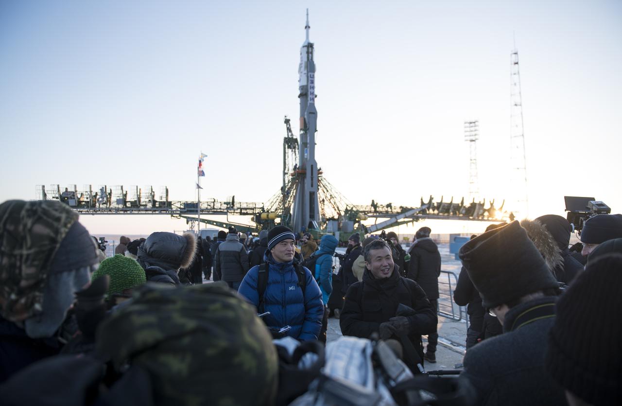Japan Aerospace Exploration Agency (JAXA) astronaut Takuya Onishi, left, Japan Aerospace Exploration Agency (JAXA) International Space Station Program Manager Koichi Wakata, right, answers questions from the media, Friday, Dec. 15, 2017, after the Soyuz rocket was raised into a vertical position on the launch pad at the Baikonur Cosmodrome in Kazakhstan. Expedition 54 Soyuz Commander Anton Shkaplerov of Roscosmos, flight engineer Scott Tingle of NASA, and flight engineer Norishige Kanai of the Japan Aerospace Exploration Agency (JAXA) are scheduled to launch at 2:21 a.m. Eastern Time (1:21 p.m. Baikonur time) on Dec. 17 and will spend the next five months living and working aboard the International Space Station.  Photo Credit: (NASA/Joel Kowsky)