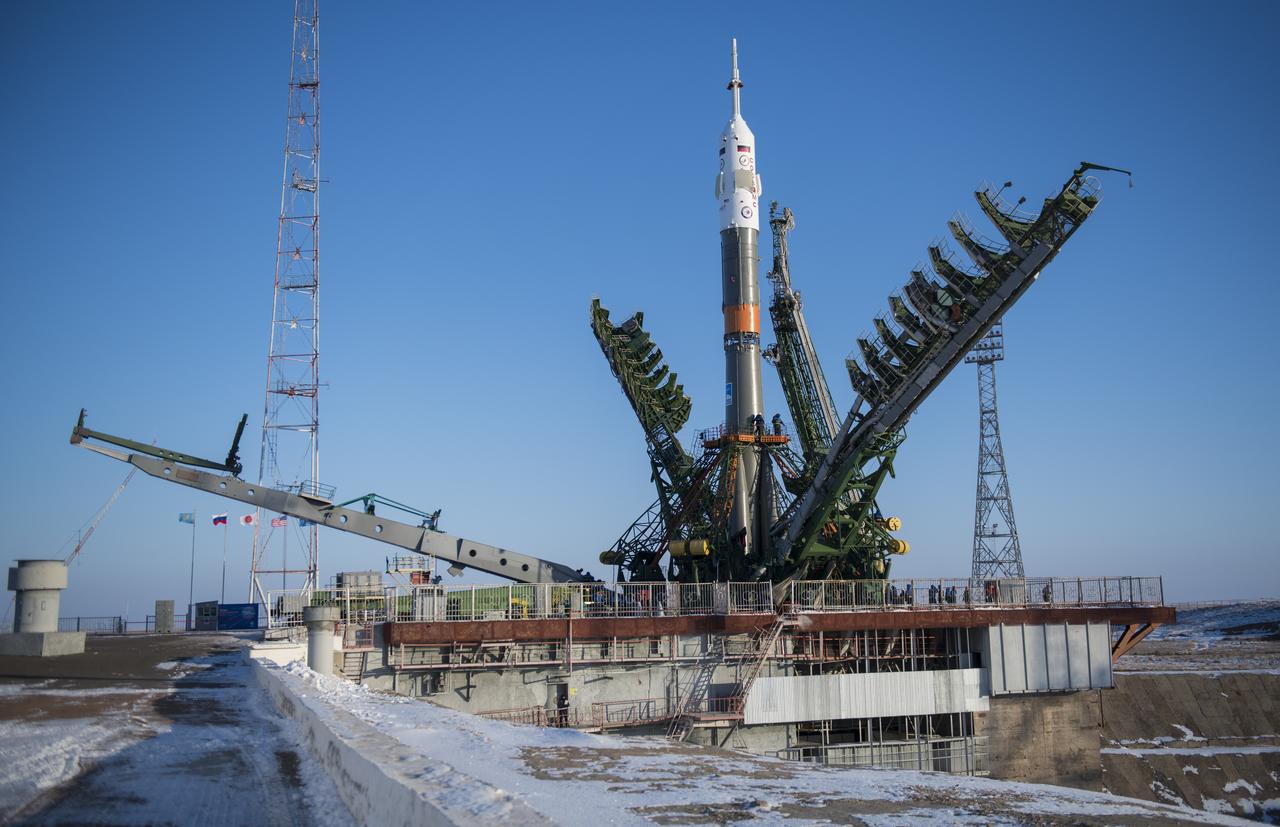 The Soyuz rocket is seen on the launch pad as the service structure arms are closed around it, Friday, Dec. 15, 2017 at the Baikonur Cosmodrome in Kazakhstan. Expedition 54 Soyuz Commander Anton Shkaplerov of Roscosmos, flight engineer Scott Tingle of NASA, and flight engineer Norishige Kanai of the Japan Aerospace Exploration Agency (JAXA) are scheduled to launch at 2:21 a.m. Eastern Time (1:21 p.m. Baikonur time) on Dec. 17 and will spend the next five months living and working aboard the International Space Station. Photo Credit: (NASA/Joel Kowsky)