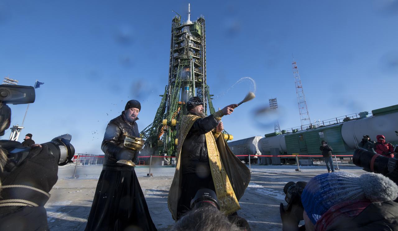 An Orthodox Priest blesses members of the media at the Baikonur Cosmodrome launch pad on Saturday, Dec. 16, 2017.  Expedition 54 Soyuz Commander Anton Shkaplerov of Roscosmos, flight engineer Scott Tingle of NASA, and flight engineer Norishige Kanai of the Japan Aerospace Exploration Agency (JAXA) are scheduled to launch to the International Space Station aboard the Soyuz spacecraft from the Baikonur Cosmodrome on Dec. 17.  Photo Credit: (NASA/Joel Kowsky)