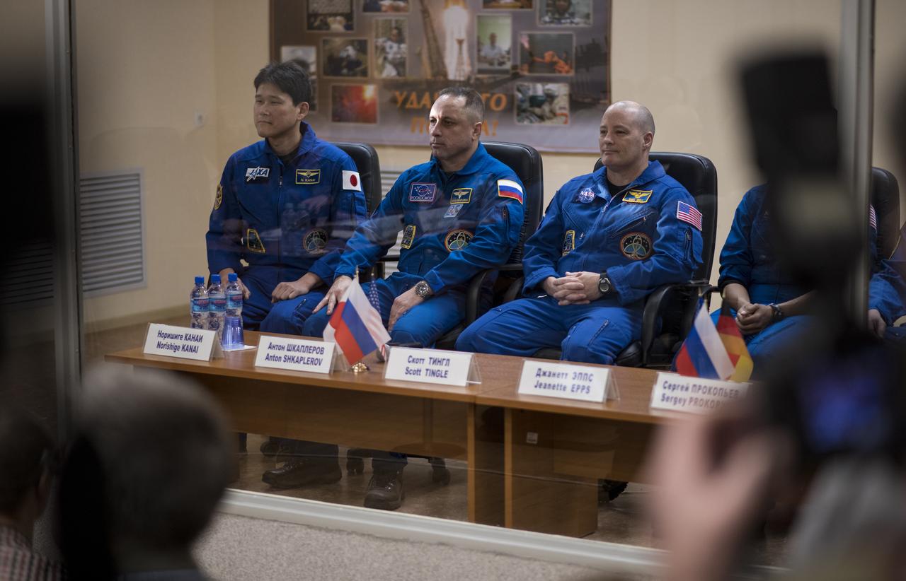 Expedition 54 prime crew members flight engineer Norishige Kanai of the Japan Aerospace Exploration Agency (JAXA), left, Soyuz Commander Anton Shkaplerov of Roscosmos, center, and flight engineer Scott Tingle of NASA, right, are seen during the State Commission meeting to approve the Soyuz launch of Expedition 54 to the International Space Station, Saturday, Dec. 16, 2017, at the Cosmonaut Hotel in Baikonur, Kazakhstan.  Kanai, Shkaplerov, and Tingle are scheduled to launch to the International Space Station aboard the Soyuz spacecraft from the Baikonur Cosmodrome on Dec. 17.  Photo Credit: (NASA/Joel Kowsky)