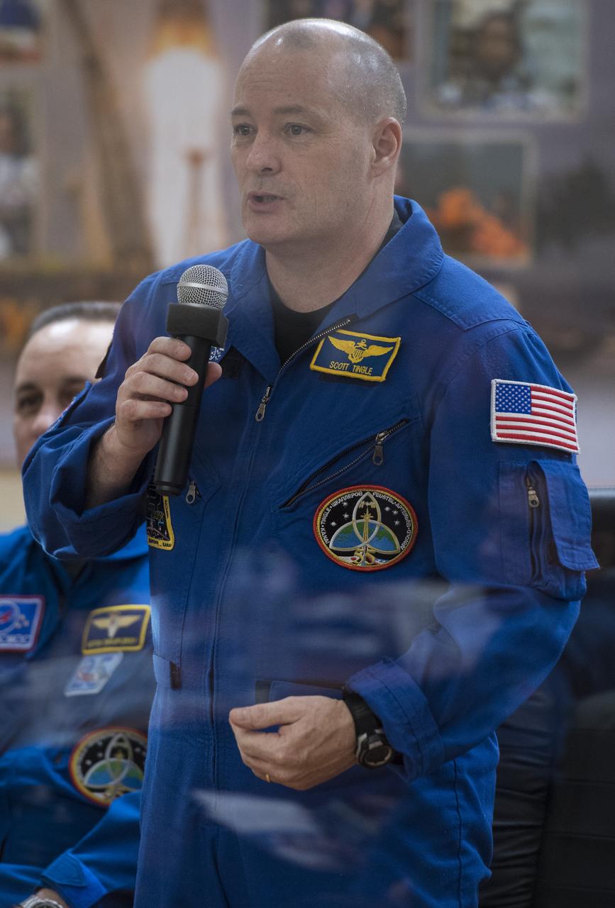 Expedition 54 flight engineer Scott Tingle speaks during the State Commission meeting to approve the Soyuz launch of Expedition 54 to the International Space Station, Saturday, Dec. 16, 2017 at the Cosmonaut Hotel in Baikonur, Kazakhstan. Tingle, Soyuz Commander Anton Shkaplerov of Roscosmos, and flight engineer Norishige Kanai of the Japan Aerospace Exploration Agency (JAXA) are scheduled to launch to the International Space Station aboard the Soyuz spacecraft from the Baikonur Cosmodrome on December 17. Photo Credit: (NASA/Joel Kowsky)