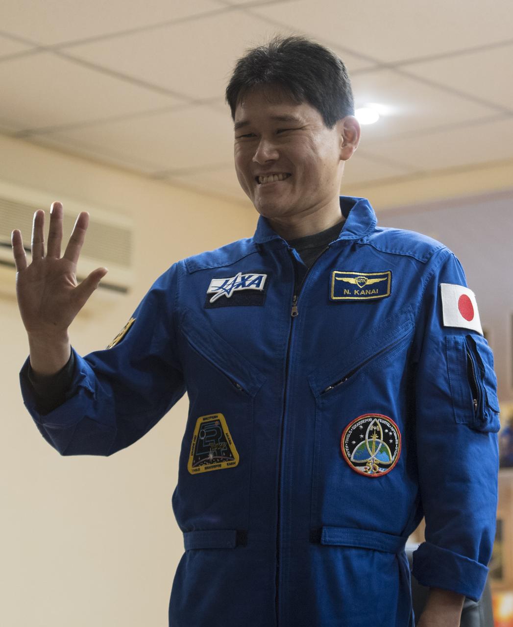 Expedition 54 flight engineer Norishige Kanai of the Japan Aerospace Exploration Agency (JAXA) is seen in quarantine, behind glass, during a press conference, Saturday, Dec. 16, 2017 at the Cosmonaut Hotel in Baikonur, Kazakhstan. Expedition 54 Soyuz Commander Anton Shkaplerov of Roscosmos, flight engineer Scott Tingle of NASA, and flight engineer Norishige Kanai of Japan Aerospace Exploration Agency (JAXA) are scheduled to launch to the International Space Station aboard the Soyuz spacecraft from the Baikonur Cosmodrome on December 17. Photo Credit: (NASA/Joel Kowsky)
