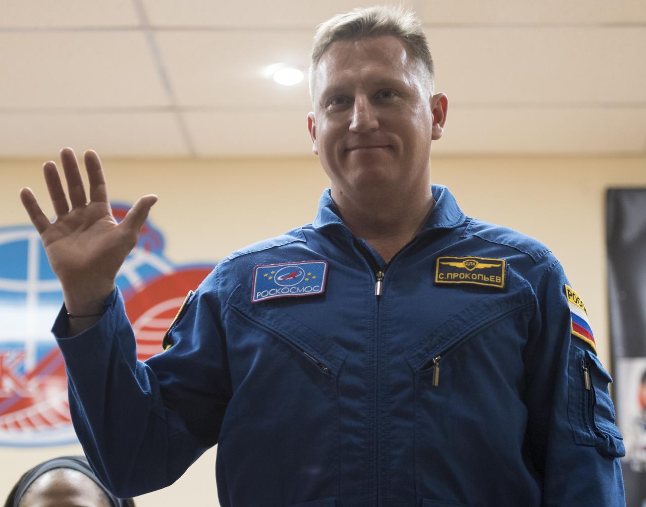 Expedition 54 backup crew member Sergey Prokopev is seen in quarantine, behind glass, during a press conference, Saturday, Dec. 16, 2017 at the Cosmonaut Hotel in Baikonur, Kazakhstan. Expedition 54 prime crew members Soyuz Commander Anton Shkaplerov of Roscosmos, flight engineer Scott Tingle of NASA, and flight engineer Norishige Kanai of the Japan Aerospace Exploration Agency (JAXA) are scheduled to launch to the International Space Station aboard the Soyuz spacecraft from the Baikonur Cosmodrome on December 17. Photo Credit: (NASA/Joel Kowsky)