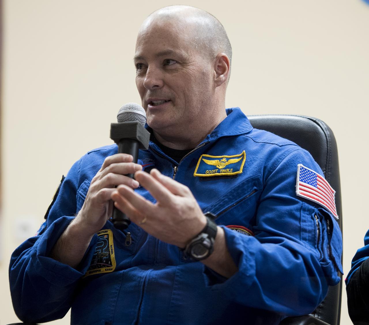 Expedition 54 flight engineer Scott Tingle of NASA answers a question during a press conference, Saturday, Dec. 16, 2017 at the Cosmonaut Hotel in Baikonur, Kazakhstan. Tingle, Soyuz Commander Anton Shkaplerov of Roscosmos, and flight engineer Norishige Kanai of the Japan Aerospace Exploration Agency (JAXA) are scheduled to launch to the International Space Station aboard the Soyuz spacecraft from the Baikonur Cosmodrome on December 17.  Photo Credit: (NASA/Joel Kowsky)