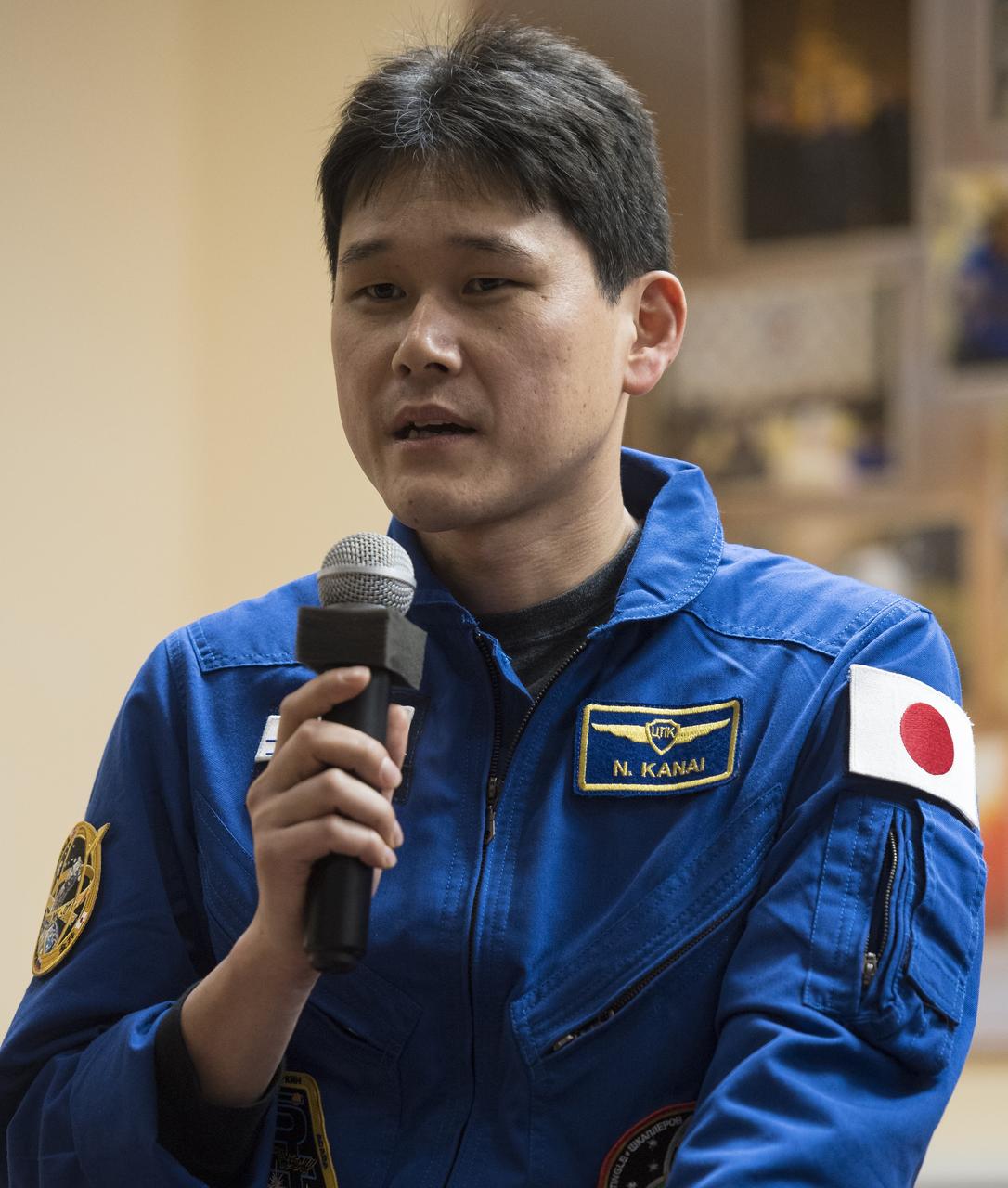 Expedition 54 flight engineer Norishige Kanai of the Japan Aerospace Exploration Agency (JAXA) answers a question during a press conference, Saturday, Dec. 16, 2017 at the Cosmonaut Hotel in Baikonur, Kazakhstan. Expedition 54 Soyuz Commander Anton Shkaplerov of Roscosmos, flight engineer Scott Tingle of NASA, and flight engineer Norishige Kanai of Japan Aerospace Exploration Agency (JAXA) are scheduled to launch to the International Space Station aboard the Soyuz spacecraft from the Baikonur Cosmodrome on December 17. Photo Credit: (NASA/Joel Kowsky)