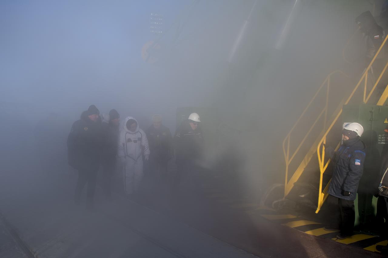 Expedition 54 Soyuz Commander Anton Shkaplerov of Roscosmos is seen as he is escorted to the base of the Soyuz rocket prior to boarding for launch, Sunday, Dec. 17, 2017 at the Baikonur Cosmodrome in Kazakhstan. Shkaplerov, flight engineer Scott Tingle of NASA, and flight engineer Norishige Kanai of Japan Aerospace Exploration Agency (JAXA) will spend the next five months living and working aboard the International Space Station.  Photo Credit: (NASA/Joel Kowsky)
