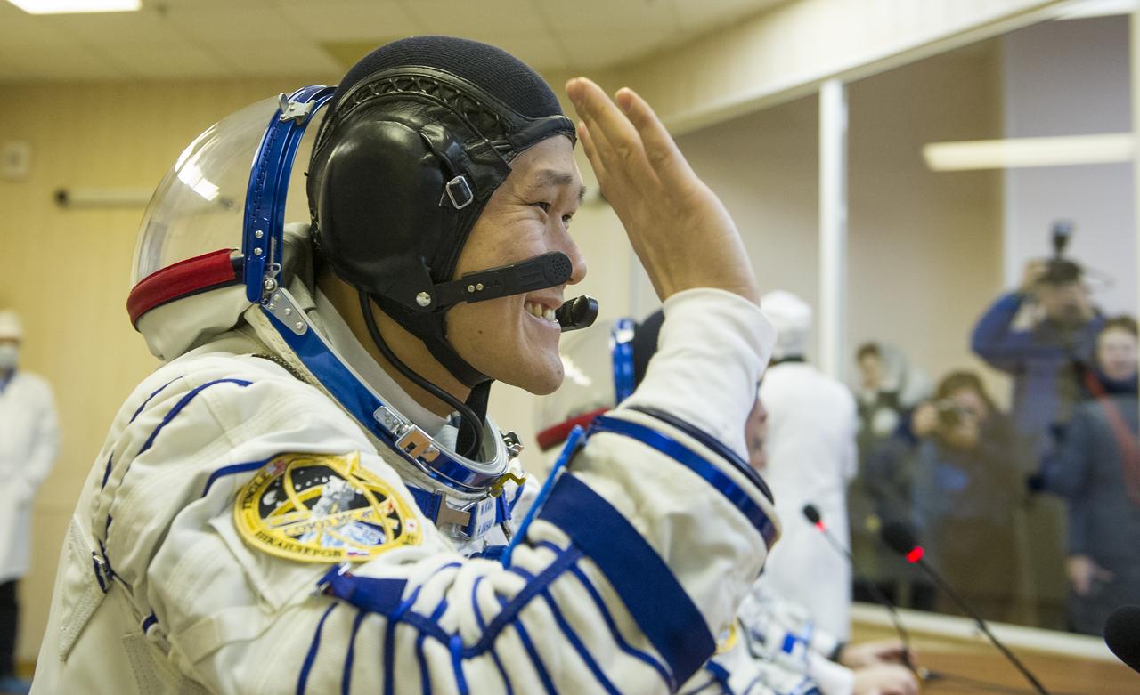 Expedition 54 flight engineer Norishige Kanai of Japan Aerospace Exploration Agency (JAXA) speaks with family and friends after having his Russian Sokol suits pressure checked ahead of the Soyuz launch to the International Space Station Sunday, Dec. 17, 2017 in Baikonur, Kazakhstan.  Launch of the Soyuz rocket will send Kanai, Soyuz Commander Anton Shkaplerov of Roscosmos, and flight engineer Scott Tingle of NASA on a five month mission aboard the International Space Station. Photo Credit: (NASA/GCTC/Andrey Shelepin)