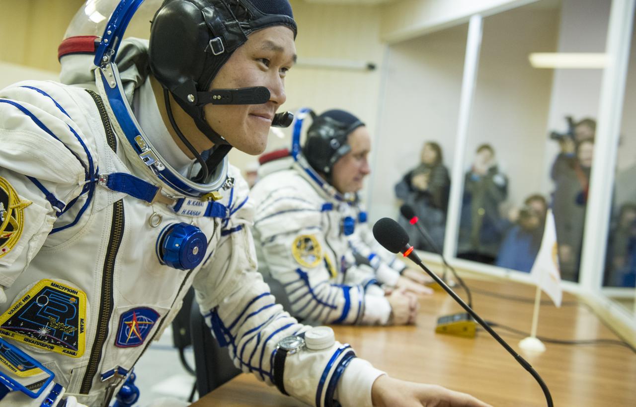 Expedition 54 flight engineer Norishige Kanai of Japan Aerospace Exploration Agency (JAXA) speaks with family and friends after having his Russian Sokol suits pressure checked ahead of the Soyuz launch to the International Space Station Sunday, Dec. 17, 2017 in Baikonur, Kazakhstan.  Launch of the Soyuz rocket will send Kanai, Soyuz Commander Anton Shkaplerov of Roscosmos, and flight engineer Scott Tingle of NASA on a five month mission aboard the International Space Station. Photo Credit: (NASA/GCTC/Andrey Shelepin)