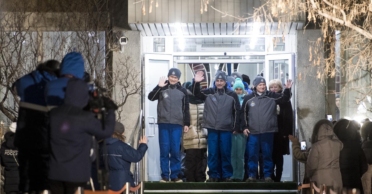 Expedition 54 flight engineer Norishige Kanai of the Japan Aerospace Exploration Agency (JAXA), left, Soyuz Commander Anton Shkaplerov of Roscosmos, center, and flight engineer Scott Tingle of NASA, right, are seen as they depart the Cosmonaut Hotel to suit-up for their Soyuz launch to the International Space Station, Sunday, Dec. 17, 2017 in Baikonur, Kazakhstan. Launch of the Soyuz rocket is scheduled for 2:21 a.m. Eastern Time (1:21 p.m. Baikonur time) on December 17 and will send Shkaplerov, Tingle, and Kanai on a five month mission aboard the International Space Station.  Photo Credit: (NASA/Joel Kowsky)