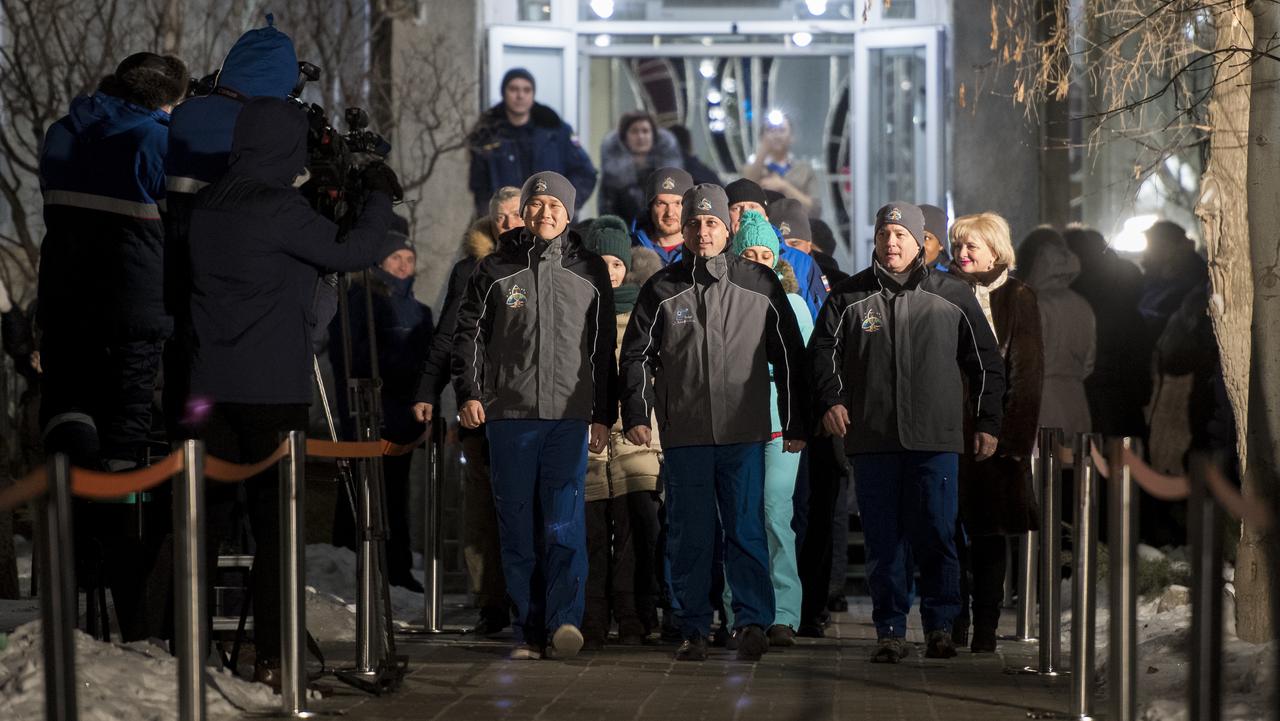 Expedition 54 flight engineer Norishige Kanai of the Japan Aerospace Exploration Agency (JAXA), left, Soyuz Commander Anton Shkaplerov of Roscosmos, center, and flight engineer Scott Tingle of NASA, right, are seen as they depart the Cosmonaut Hotel to suit-up for their Soyuz launch to the International Space Station, Sunday, Dec. 17, 2017 in Baikonur, Kazakhstan. Launch of the Soyuz rocket is scheduled for 2:21 a.m. Eastern Time (1:21 p.m. Baikonur time) on December 17 and will send Shkaplerov, Tingle, and Kanai on a five month mission aboard the International Space Station.  Photo Credit: (NASA/Joel Kowsky)