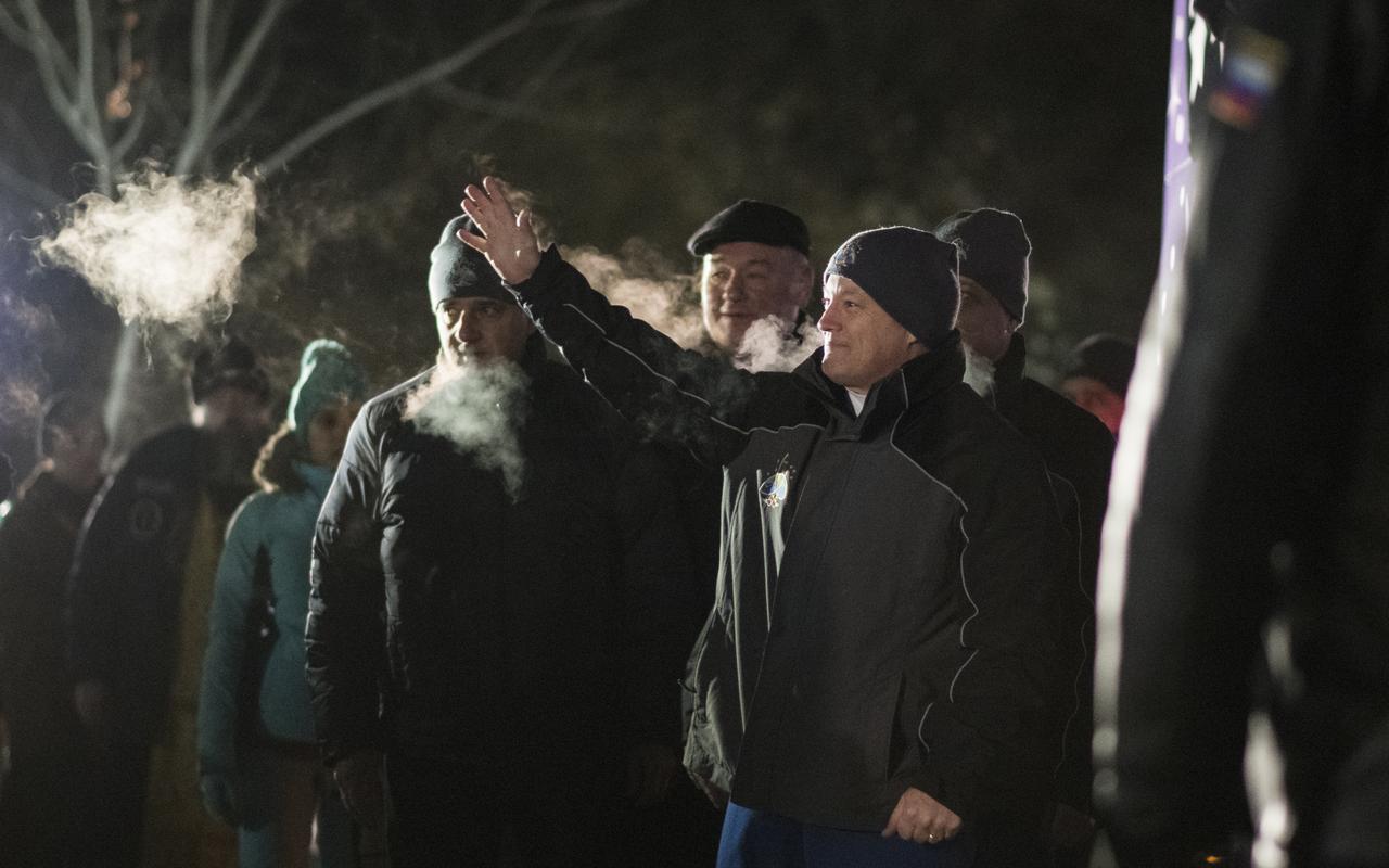 Expedition 54 flight engineer Scott Tingle of NASA waves to family and friends as he departs the Cosmonaut Hotel to suit-up for their Soyuz launch to the International Space Station, Sunday, Dec. 17, 2017 in Baikonur, Kazakhstan. Launch of the Soyuz rocket is scheduled for 2:21 a.m. Eastern Time (1:21 p.m. Baikonur time) on December 17 and will send Tingle, Soyuz Commander Anton Shkaplerov of Roscosmos and flight engineer Norishige Kanai of the Japan Aerospace Exploration Agency (JAXA) on a five month mission aboard the International Space Station.  Photo Credit: (NASA/Joel Kowsky)