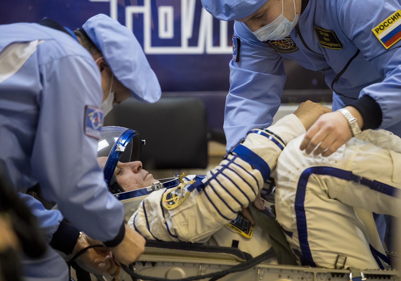 Expedition 54 Soyuz Commander Anton Shkaplerov of Roscosmos prepares to have his Russian Sokol suit pressure checked in preparation for launch aboard the Soyuz MS-07 spacecraft, Sunday, Dec. 17, 2017 at the Baikonur Cosmodrome Kazakhstan. Launch of the Soyuz rocket will send Shkaplerov and fellow crewmates flight engineer Scott Tingle of NASA and flight engineer Norishige Kanai of Japan Aerospace Exploration Agency (JAXA) on a five month mission aboard the International Space Station. Photo Credit: (NASA/Joel Kowsky)