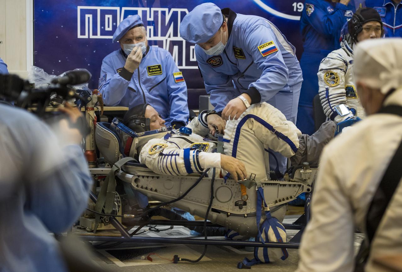 Expedition 54 flight engineer Scott Tingle of NASA prepares to have his Russian Sokol suit pressure checked in preparation for launch aboard the Soyuz MS-07 spacecraft, Sunday, Dec. 17, 2017 at the Baikonur Cosmodrome  Kazakhstan. Launch of the Soyuz rocket will send Tingle and fellow crewmates Soyuz Commander Anton Shkaplerov of Roscosmos and flight engineer Norishige Kanai of the Japan Aerospace Exploration Agency (JAXA) on a five month mission aboard the International Space Station.  Photo Credit: (NASA/Joel Kowsky)