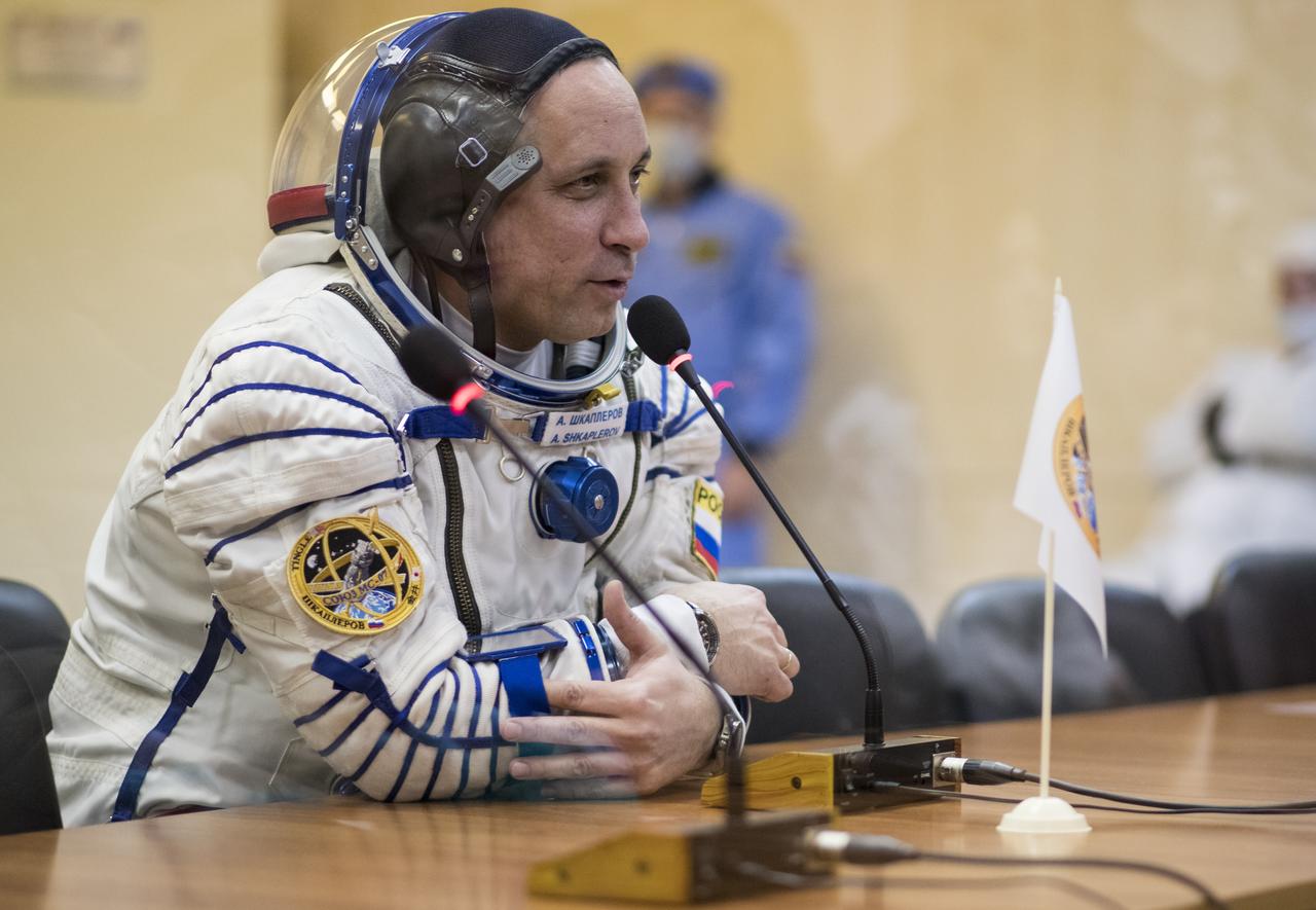 Expedition 54 Soyuz Commander Anton Shkaplerov of Roscosmos speaks with family and friends after having his Russian Sokol suit pressure checked in preparation for launch aboard the Soyuz MS-07 spacecraft, Sunday, Dec. 17, 2017 at the Baikonur Cosmodrome  Kazakhstan. Launch of the Soyuz rocket will send Shkaplerov and fellow crewmates flight engineer Scott Tingle of NASA and flight engineer Norishige Kanai of Japan Aerospace Exploration Agency (JAXA) on a five month mission aboard the International Space Station.  Photo Credit: (NASA/Joel Kowsky)