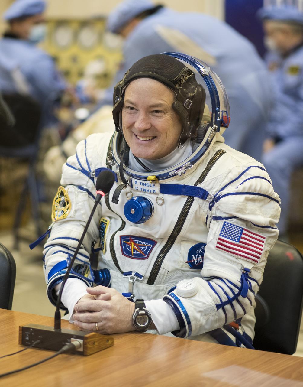 Expedition 54 flight engineer Scott Tingle of NASA speaks with family and friends after having his Russian Sokol suit pressure checked in preparation for launch aboard the Soyuz MS-07 spacecraft, Sunday, Dec. 17, 2017 at the Baikonur Cosmodrome  Kazakhstan. Launch of the Soyuz rocket will send Tingle and fellow crewmates Soyuz Commander Anton Shkaplerov of Roscosmos and flight engineer Norishige Kanai of the Japan Aerospace Exploration Agency (JAXA) on a five month mission aboard the International Space Station.  Photo Credit: (NASA/Joel Kowsky)
