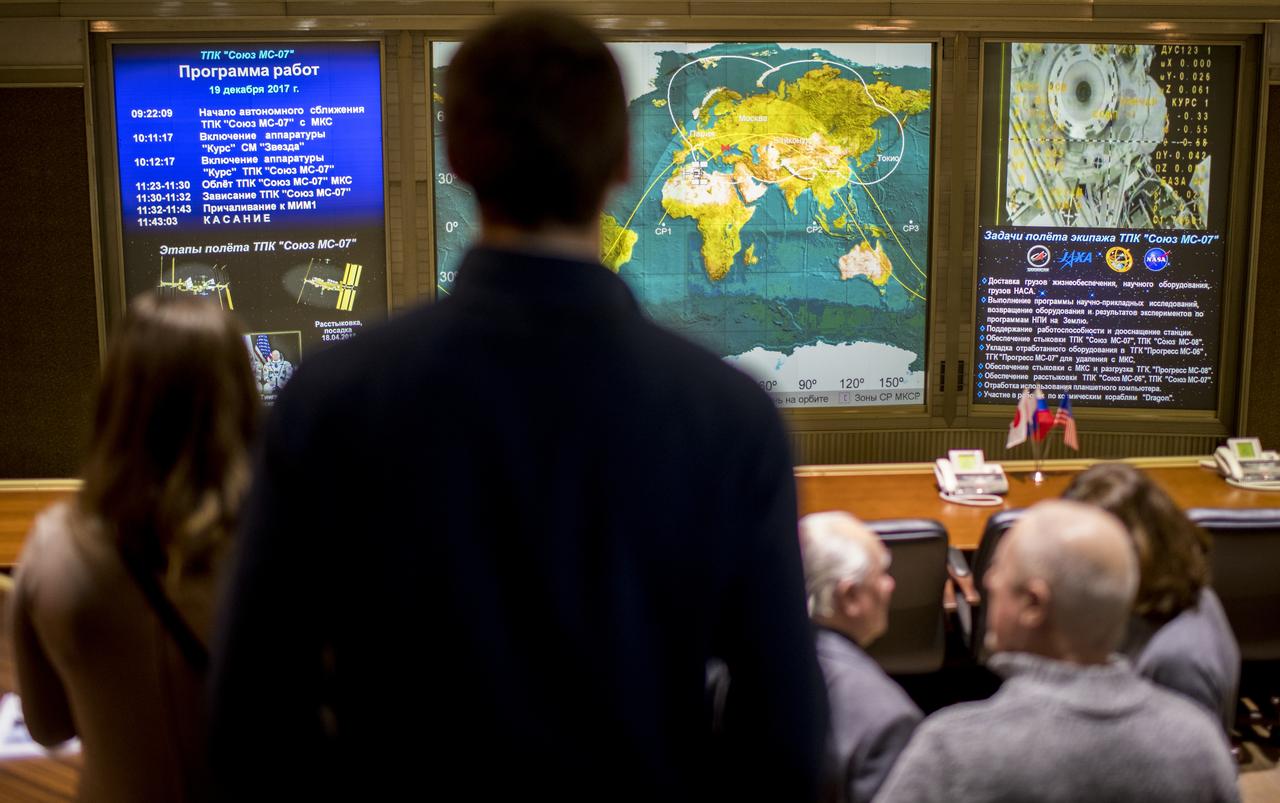 Friends and family members of the Soyuz MS-07 crew watch a live view of the International Space Station, as seen by cameras onboard the spacecraft with Expedition 54-55 crewmembers Anton Shkaplerov of Roscosmos, Scott Tingle of NASA, and Norishige Kanai of the Japan Aerospace Exploration Agency (JAXA) onboard, on screens at the Moscow Mission Control Center as the spacecraft approaches for docking, Tuesday, Dec. 19, 2017 in Korolev, Russia. The Soyuz MS-07 spacecraft carrying Shkaplerov, Tingle, and Kanai docked with the International Space Station at 3:39 a.m. EST, Tuesday, Dec. 19 while 250 statute miles over the southern coast of Italy and joined Expedition 54 Commander  Alexander Misurkin of Roscosmos, and NASA astronauts Joe Acaba and Mark Vande Hei. Photo Credit: (NASA/Joel Kowsky)