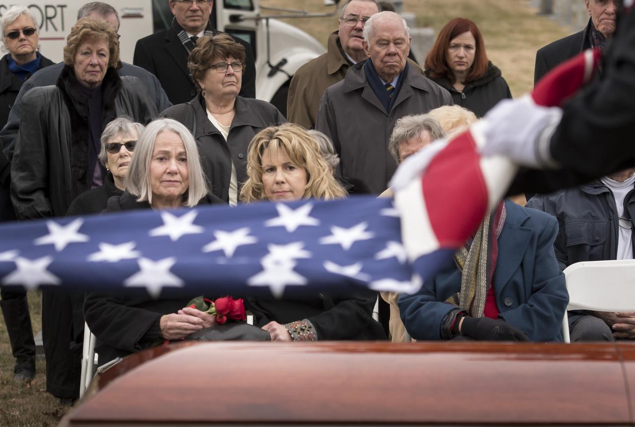 Family and friends watch as the flag that draped the casket of former NASA astronaut Captain Bruce McCandless II, USN (Ret.) is folded during his interment service, Tuesday, Jan. 16, 2018 at the United States Naval Academy Cemetery in Annapolis, Maryland. Photo Credit: (NASA/Bill Ingalls)