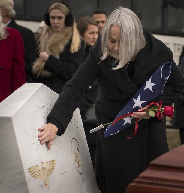 Ellen Shields McCandless, wife of former NASA astronaut Captain Bruce McCandless II, USN (Ret.), left, pays her respects during her husband's interment service, Tuesday, Jan. 16, 2018 at the United States Naval Academy Cemetery in Annapolis, Maryland. Photo Credit: (NASA/Bill Ingalls)