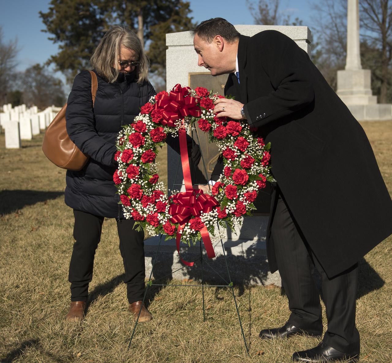 Kristy Carroll, family friend of the late space shuttle Columbia astronaut William McCool, and acting NASA Administrator Robert Lightfoot lay a wreath at the Space Shuttle Columbia Memorial as part of NASA's Day of Remembrance, Thursday, Jan. 25, 2018, at Arlington National Cemetery in Arlington, Virginia. Wreaths were laid in memory of those men and women who lost their lives in the quest for space exploration. Photo Credit: (NASA/Bill Ingalls)