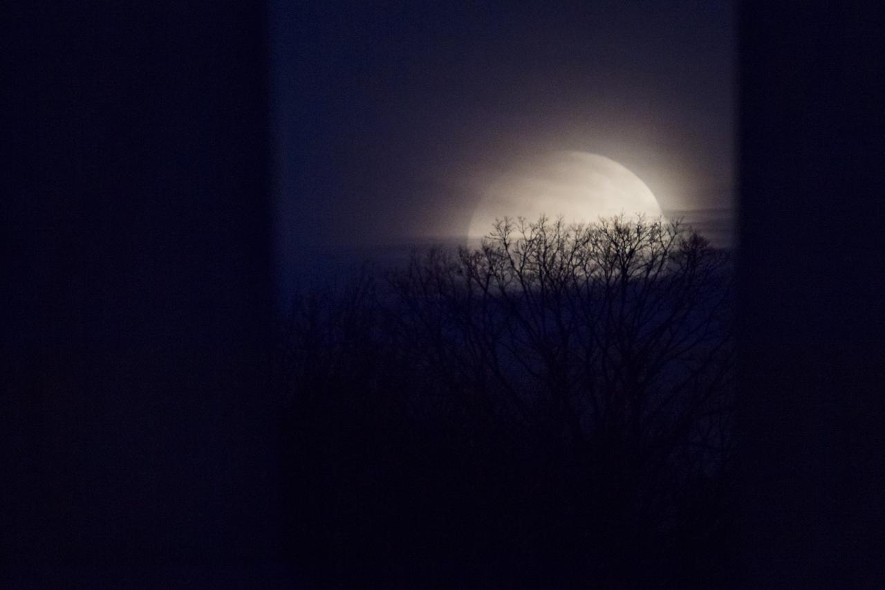 The Moon is seen as it sets behind the National Capitol Columns at The US National Arboretum on Wednesday, Jan. 31, 2018 in Washington. Today’s full Moon is unique for three reasons: it is the third in a series of supermoons, occurring when the Moon is closer to Earth in its orbit. It is also the second full moon of the month, commonly known as a blue moon. The moon will also be passing through Earth’s shadow, giving skywatchers in the right locations a view of a total lunar eclipse. Photo Credit: (NASA/Aubrey Gemignani)