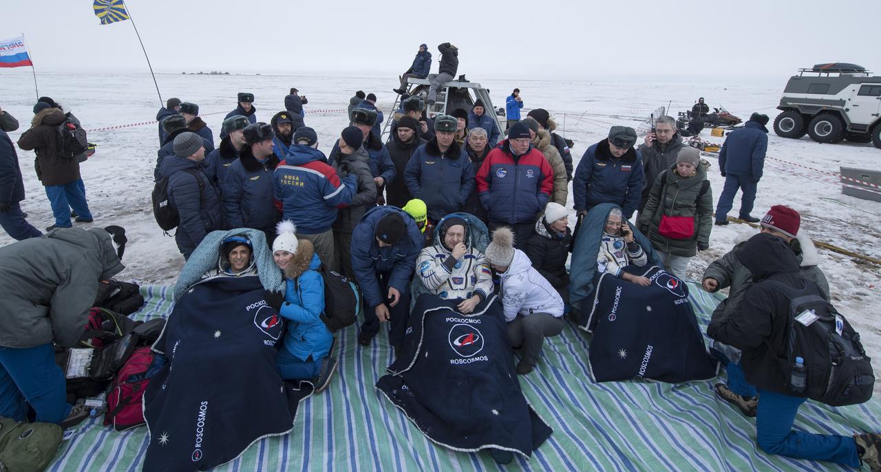 NASA astronaut Joe Acaba, left, Russian cosmonaut Alexander Misurkin, center, and NASA astronaut Mark Vande Hei sit in chairs outside the Soyuz MS-06 spacecraft after they landed in a remote area near the town of Zhezkazgan, Kazakhstan on Wednesday, Feb. 28, 2018 (February 27 Eastern time.) Acaba, Vande Hei, and Misurkin are returning after 168 days in space where they served as members of the Expedition 53 and 54 crews onboard the International Space Station. Photo Credit: (NASA/Bill Ingalls)
