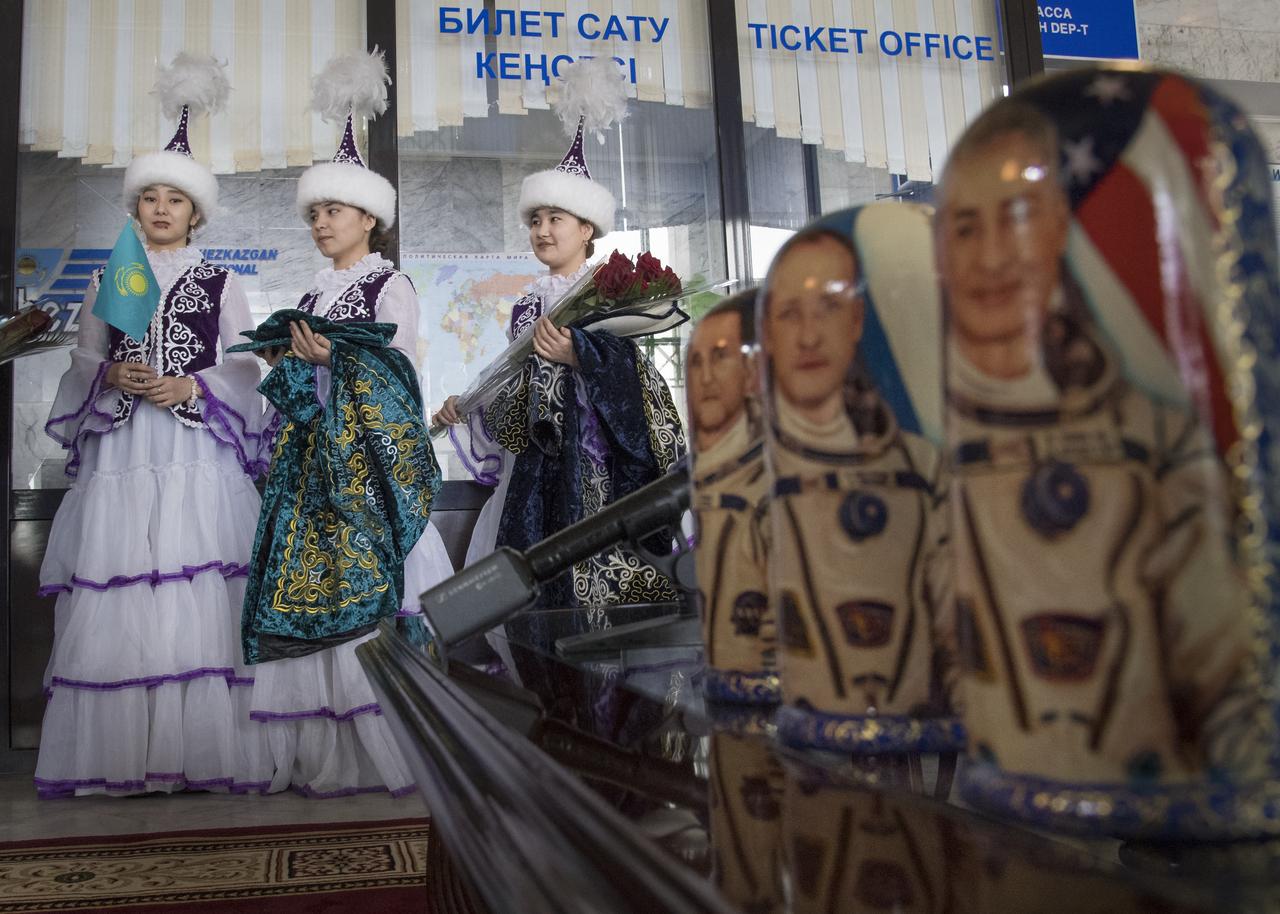 Girls in ceremonial Kazakh dress and Matryoshka Dolls depicting NASA astronaut Joe Acaba, left, Russian cosmonaut Alexander Misurkin, center, and NASA astronaut Mark Vande Hei are seen during a welcome ceremony Wednesday, Feb. 28, 2018 in the Zhezkazgan Airport, Kazakhstan.  Acaba, Vande Hei, and Misurkin are returning after 168 days in space where they served as members of the Expedition 53 and 54 crews onboard the International Space Station. Photo Credit: (NASA/Bill Ingalls)