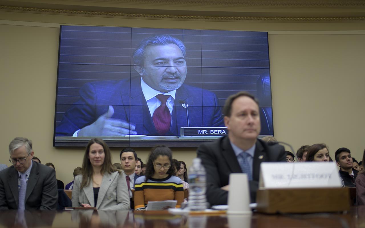 Rep. Ami Bera, D-Calif., is seen on a monitor behind acting NASA Administrator Robert Lightfoot during a House Committee on Science, Space, and Technology, Subcommittee on Space, hearing overview of the NASA Budget for Fiscal Year 2019, Wednesday, March 7, 2018, at the Rayburn House Office Building in Washington. Photo Credit: (NASA/Bill Ingalls)