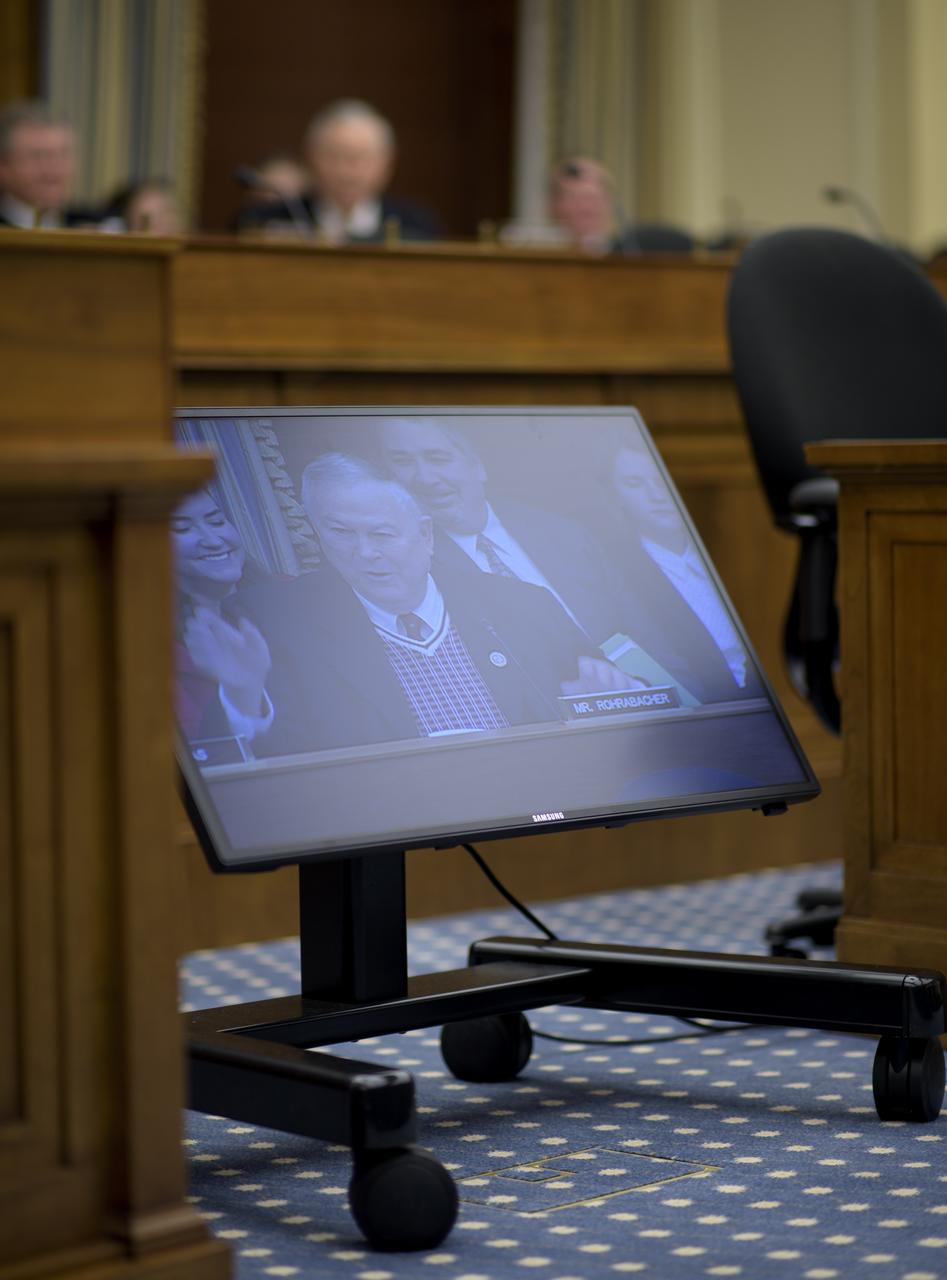 Rep. Dana Rohrabacher, R-Calif., is seen on a monitor during a House Committee on Science, Space, and Technology, Subcommittee on Space, hearing overview of the NASA Budget for Fiscal Year 2019, Wednesday, March 7, 2018, at the Rayburn House Office Building in Washington. Photo Credit: (NASA/Bill Ingalls)