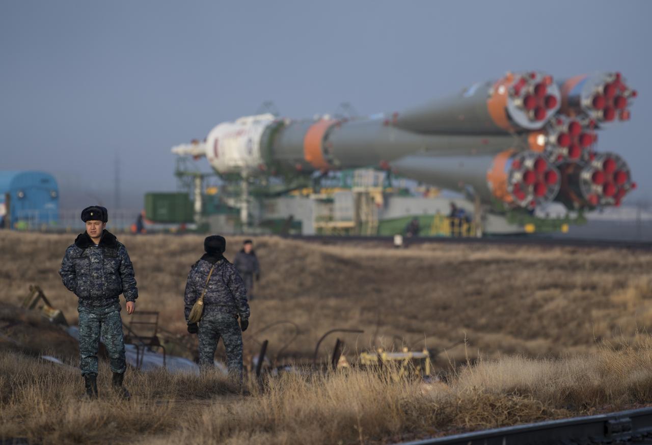 Security personnel are seen as the Soyuz rocket is rolled out by train to the launch pad, Monday, March 19, 2018 at the Baikonur Cosmodrome in Kazakhstan. Expedition 55 crewmembers Ricky Arnold and Drew Feustel of NASA and Oleg Artemyev of Roscosmos are scheduled to launch at 1:44 p.m. Eastern time (11:44 p.m. Baikonur time) on March 21 and will spend the next five months living and working aboard the International Space Station.  Photo Credit: (NASA/Joel Kowsky)