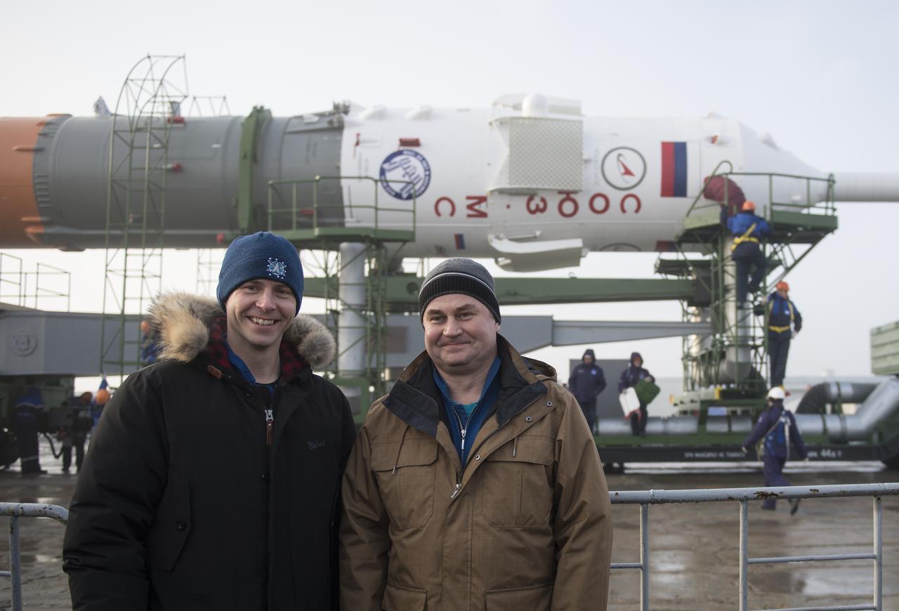 Expedition 55 backup crewmembers Nick Hague of NASA, left, and Alexey Ovchinin of Roscosmos pose for a picture as the Soyuz rocket is rolled out to the pad, Monday, March 19, 2018 at the Baikonur Cosmodrome in Kazakhstan. Expedition 55 crewmembers Ricky Arnold and Drew Feustel of NASA and Oleg Artemyev of Roscosmos are scheduled to launch at 1:44 p.m. Eastern time (11:44 p.m. Baikonur time) on March 21 and will spend the next five months living and working aboard the International Space Station. Photo Credit: (NASA/Joel Kowsky)