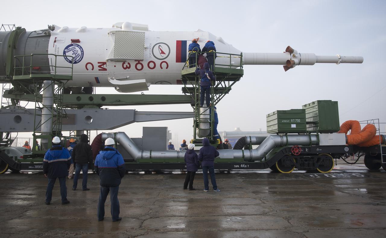 Workers prepare to raise the Soyuz rocket into a vertical position on the pad, Monday, March 19, 2018 at the Baikonur Cosmodrome in Kazakhstan. Expedition 55 crewmembers Ricky Arnold and Drew Feustel of NASA and Oleg Artemyev of Roscosmos are scheduled to launch at 1:44 p.m. Eastern time (11:44 p.m. Baikonur time) on March 21 and will spend the next five months living and working aboard the International Space Station.  Photo Credit: (NASA/Joel Kowsky)