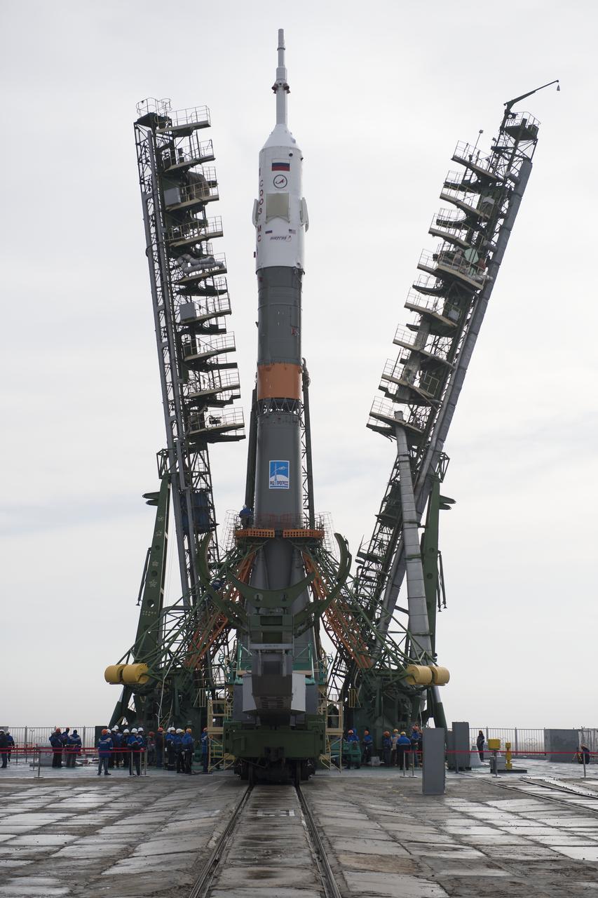 The Soyuz rocket is seen on the launch pad as the service structure arms are closed around it, Monday, March 19, 2018 at the Baikonur Cosmodrome in Kazakhstan. Expedition 55 crewmembers Ricky Arnold and Drew Feustel of NASA and Oleg Artemyev of Roscosmos are scheduled to launch at 1:44 p.m. Eastern time (11:44 p.m. Baikonur time) on March 21 and will spend the next five months living and working aboard the International Space Station.  Photo Credit: (NASA/Joel Kowsky)