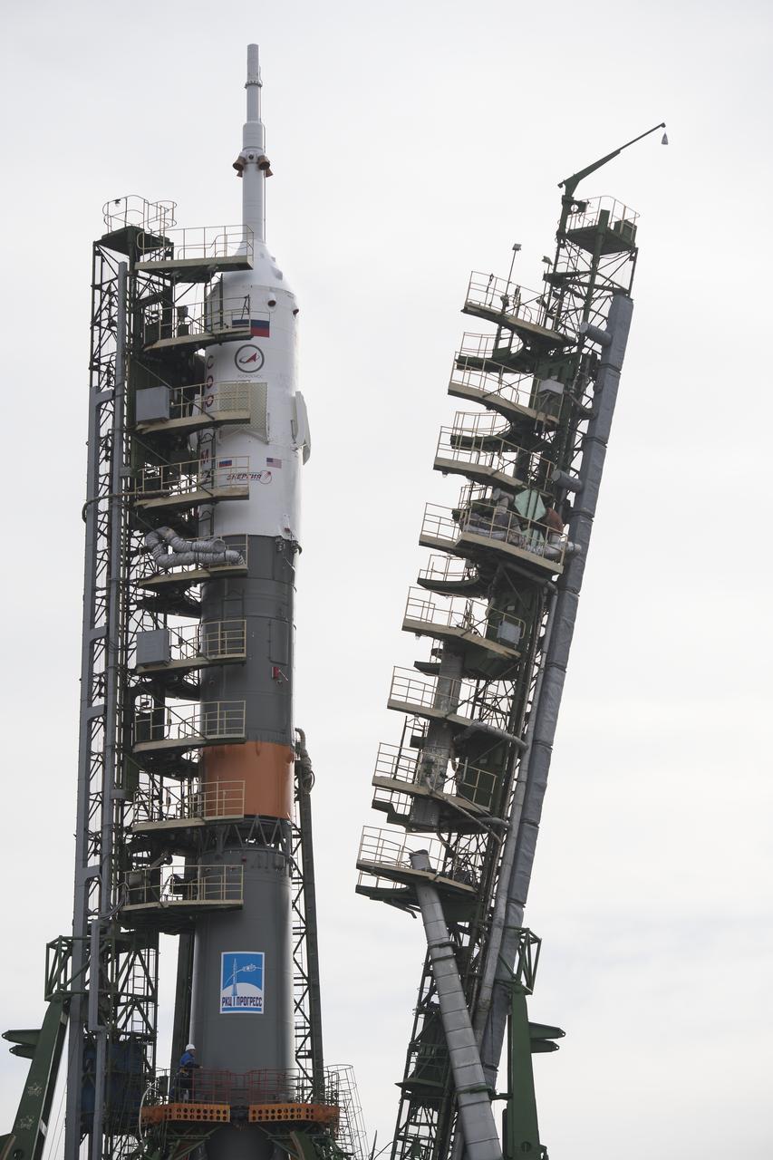 The Soyuz rocket is seen on the launch pad as the service structure arms are closed around it, Monday, March 19, 2018 at the Baikonur Cosmodrome in Kazakhstan. Expedition 55 crewmembers Ricky Arnold and Drew Feustel of NASA and Oleg Artemyev of Roscosmos are scheduled to launch at 1:44 p.m. Eastern time (11:44 p.m. Baikonur time) on March 21 and will spend the next five months living and working aboard the International Space Station.  Photo Credit: (NASA/Joel Kowsky)