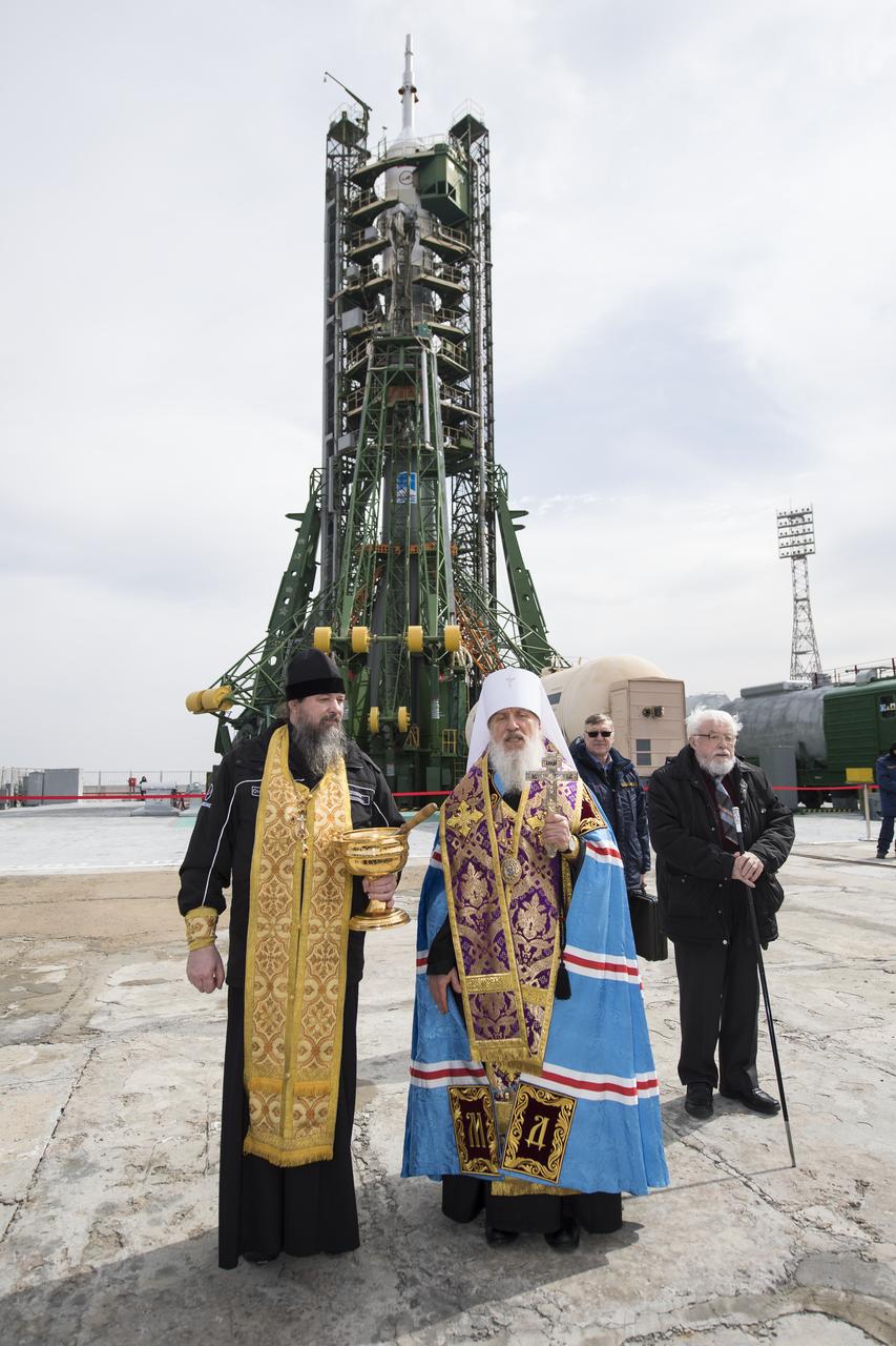 An Orthodox Priest blesses members of the media at the Baikonur Cosmodrome launch pad, Tuesday, March 20, 2018 in Baikonur, Kazakhstan. Expedition 55 Soyuz Commander Oleg Artemyev of Roscosmos, Ricky Arnold and Drew Feustel of NASA are scheduled to launch to the International Space Station aboard the Soyuz MS-08 spacecraft on Wednesday, March, 21. Photo Credit: (NASA/Joel Kowsky)